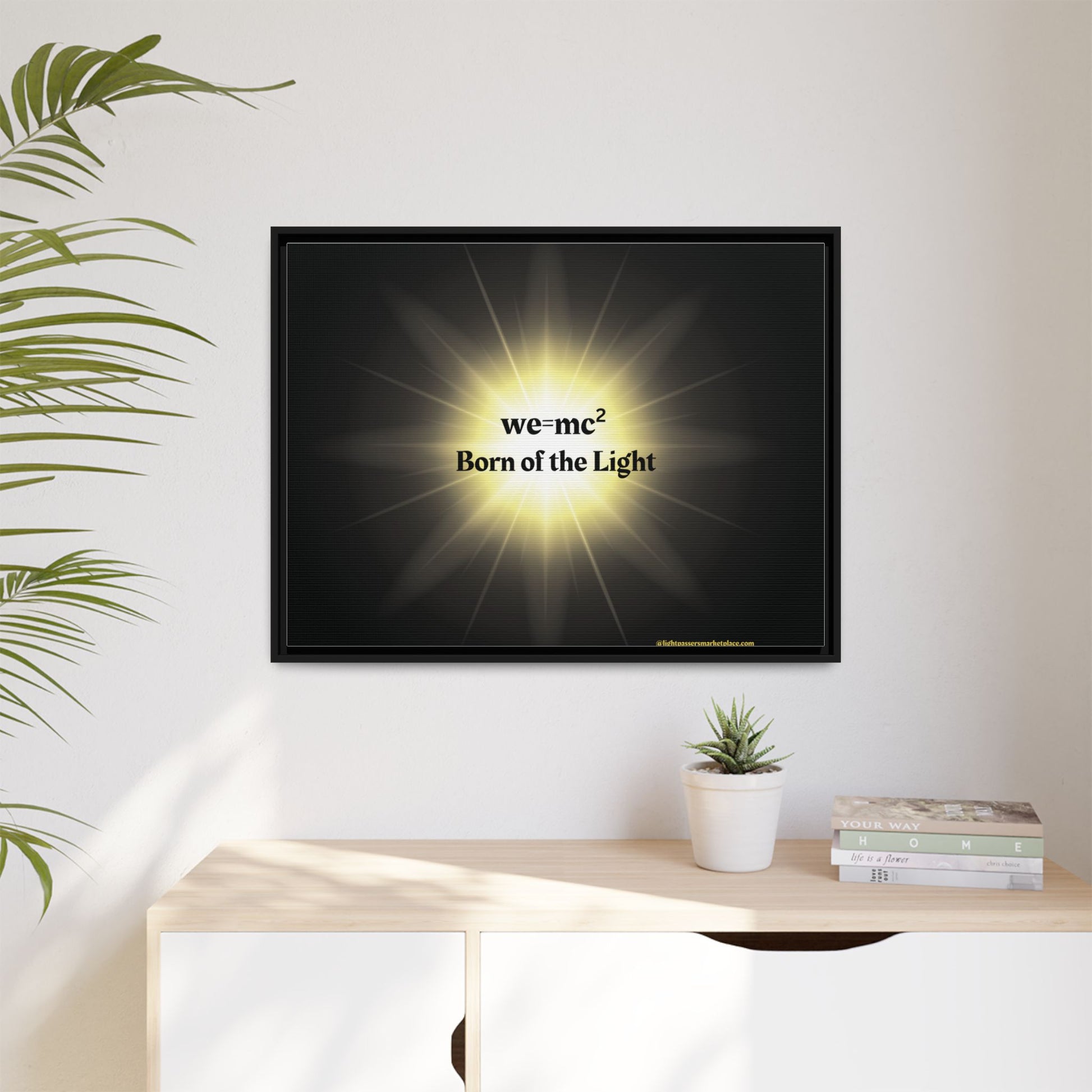 Inspirational Framed Canvas Art - we=mc² Born of the Light, displayed in a room with a potted plant on a table, enhancing any space with positivity.