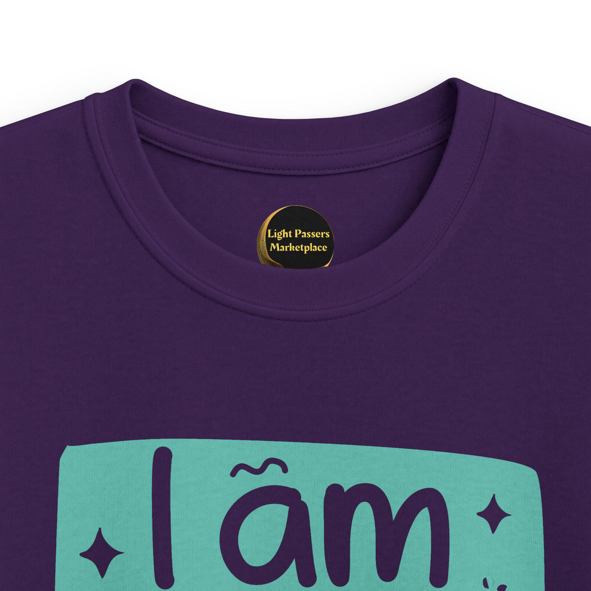 Purple youth graphic T-shirt close-up with 'I am BRAVE' slogan on teal print