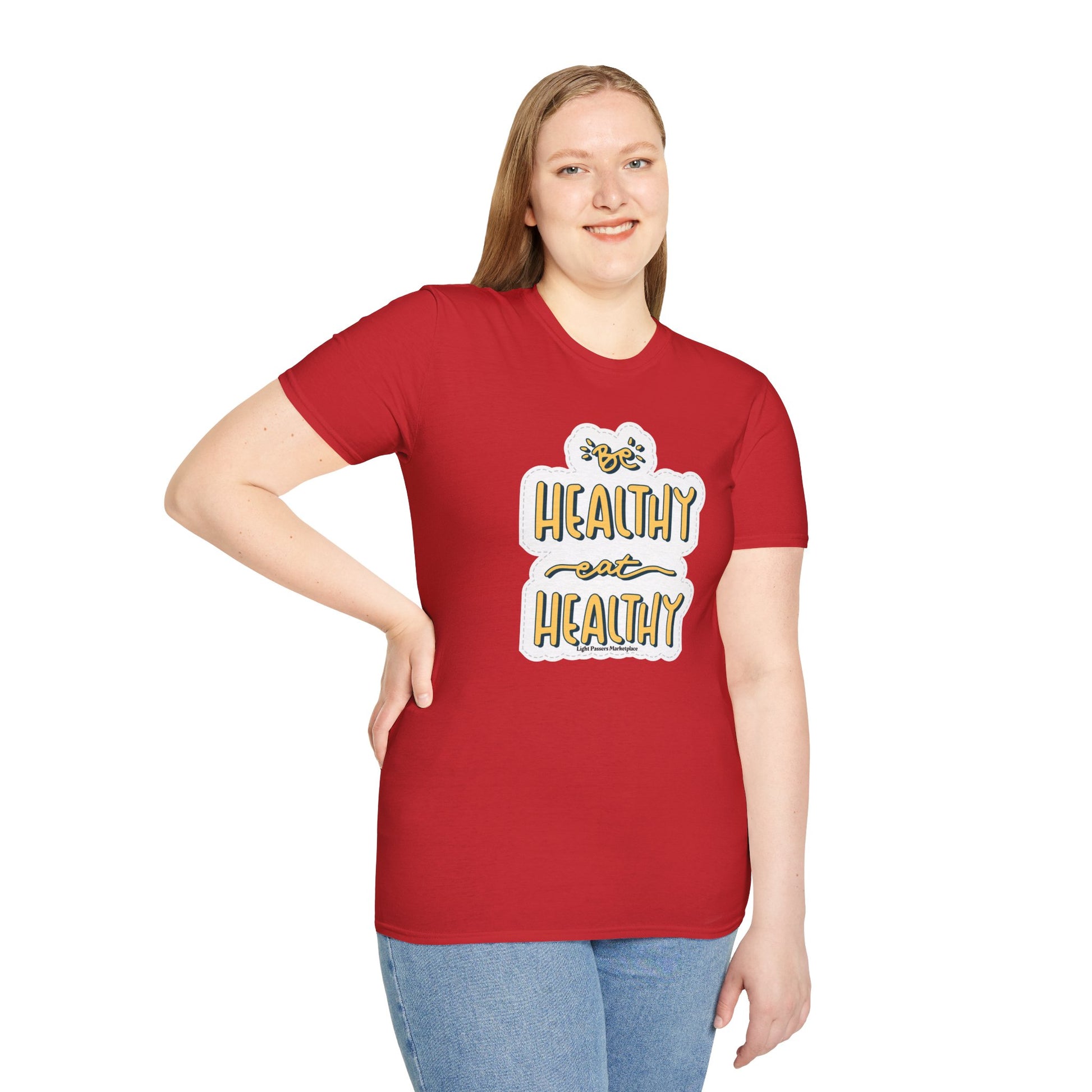 A woman in a red shirt smiles, showcasing the Be Healthy Eat Healthy Unisex T-Shirt. Soft 100% cotton, twill tape shoulders, no side seams, ribbed collar, and tear-away label for comfort.