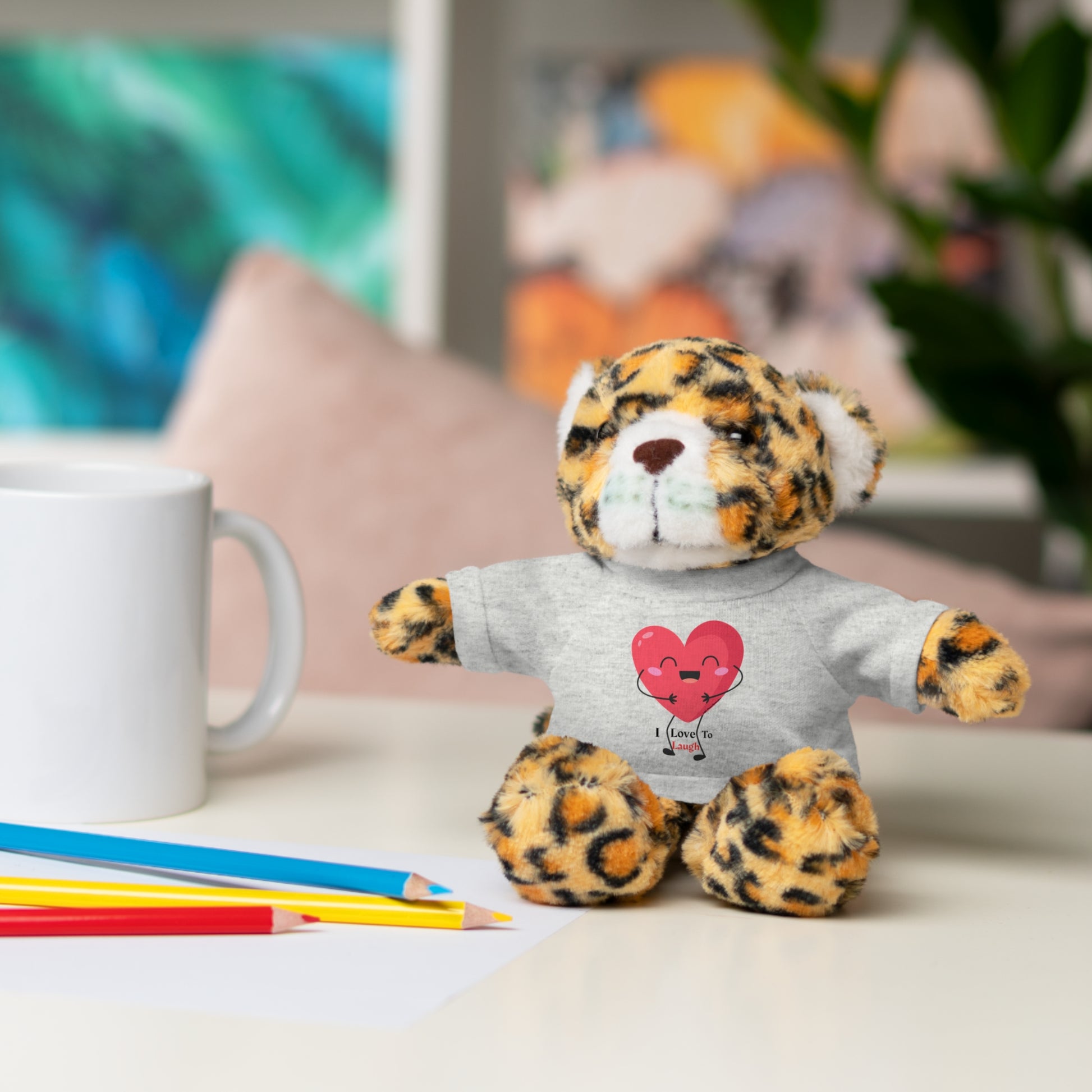 Cool Stuff Stuffies Choice of 6 Animals I Love to Laugh Heart Removable T-shirt featuring a stuffed animal with a customizable shirt on a table.
