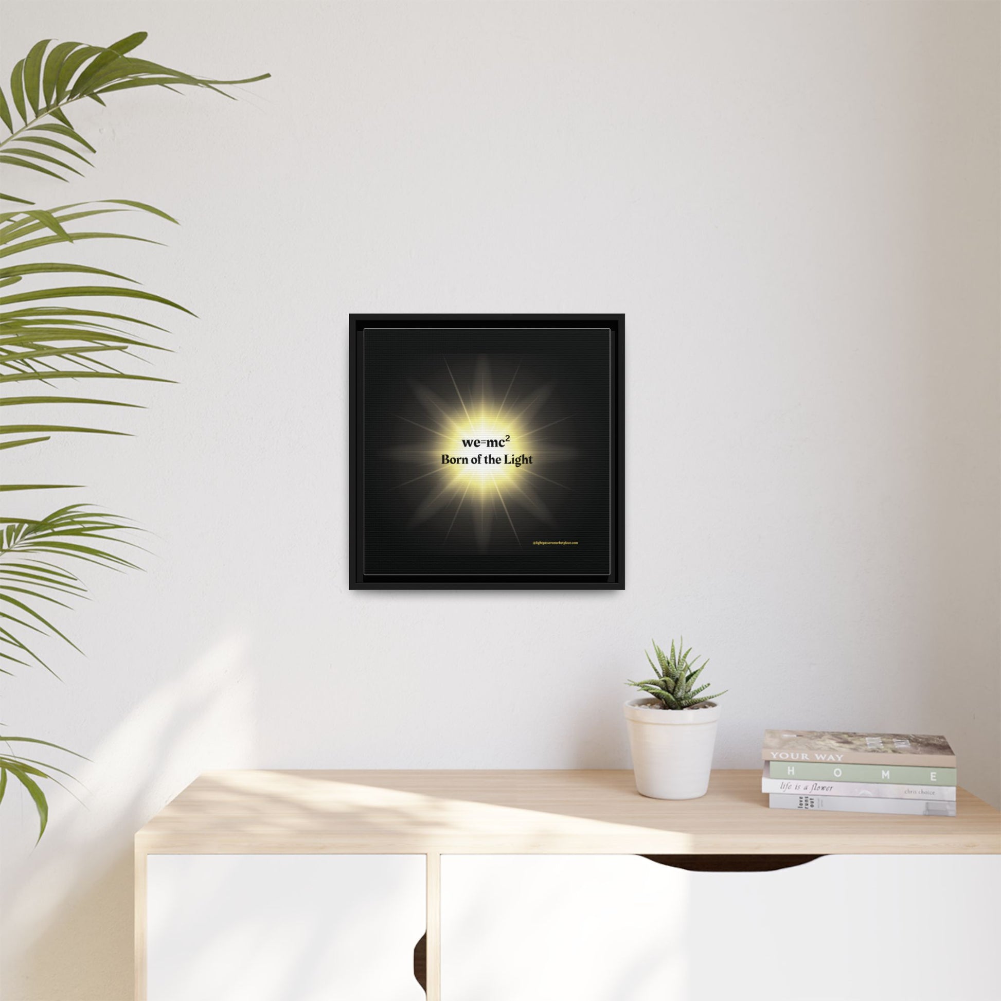 Inspirational Framed Canvas Art - we=mc² Born of the Light, featuring vibrant, eye-catching design, framed and displayed on a wall beside a potted plant.