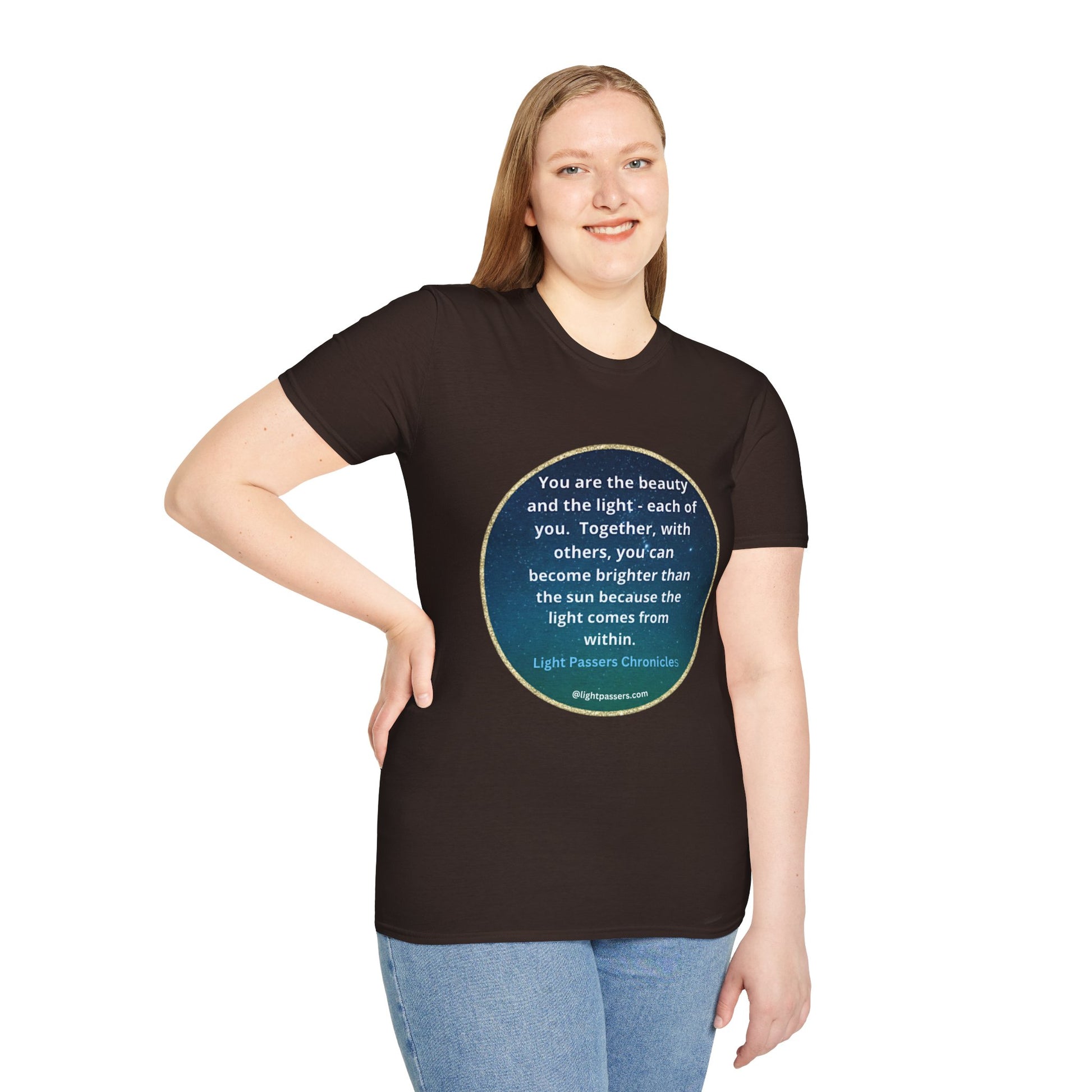 A woman in a black shirt poses, showcasing the Beauty and the Light Unisex T-shirt. Close-up of blue jeans. Text: blue circle with white text.