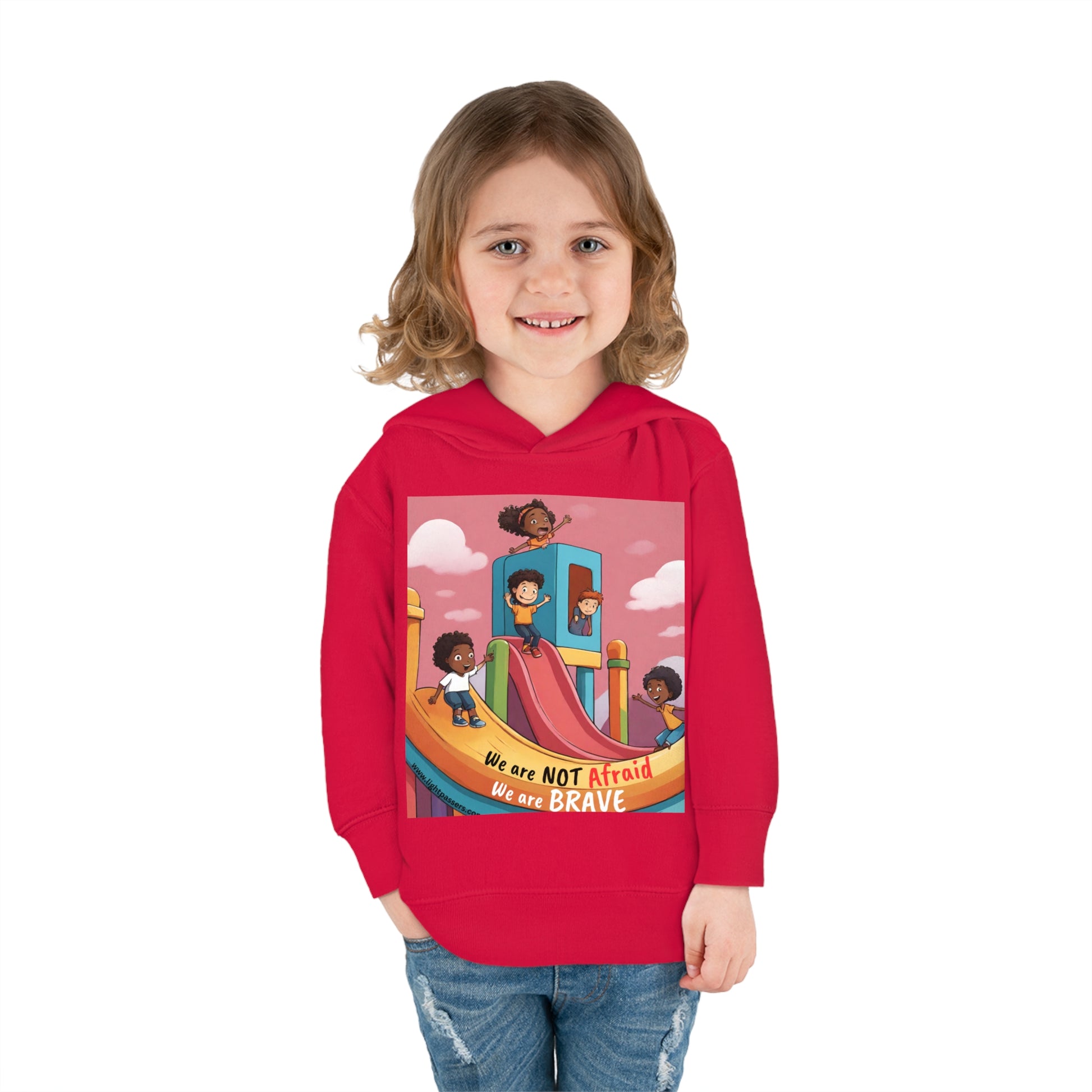 A smiling girl in a Rabbit Skins toddler hoodie with a slide design. Features jersey-lined hood, cover-stitched details, side seam pockets, and durable cotton-polyester blend for cozy wear.