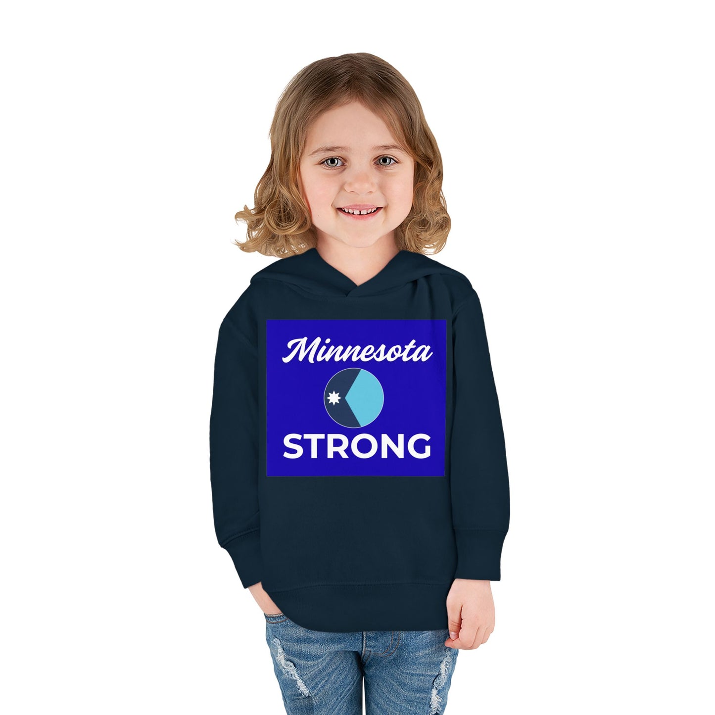 Toddler wearing Minnesota Strong navy hoodie with emblem, light-wash jeans, smiling. Cozy fleece, functional pockets; perfect for showing state pride.