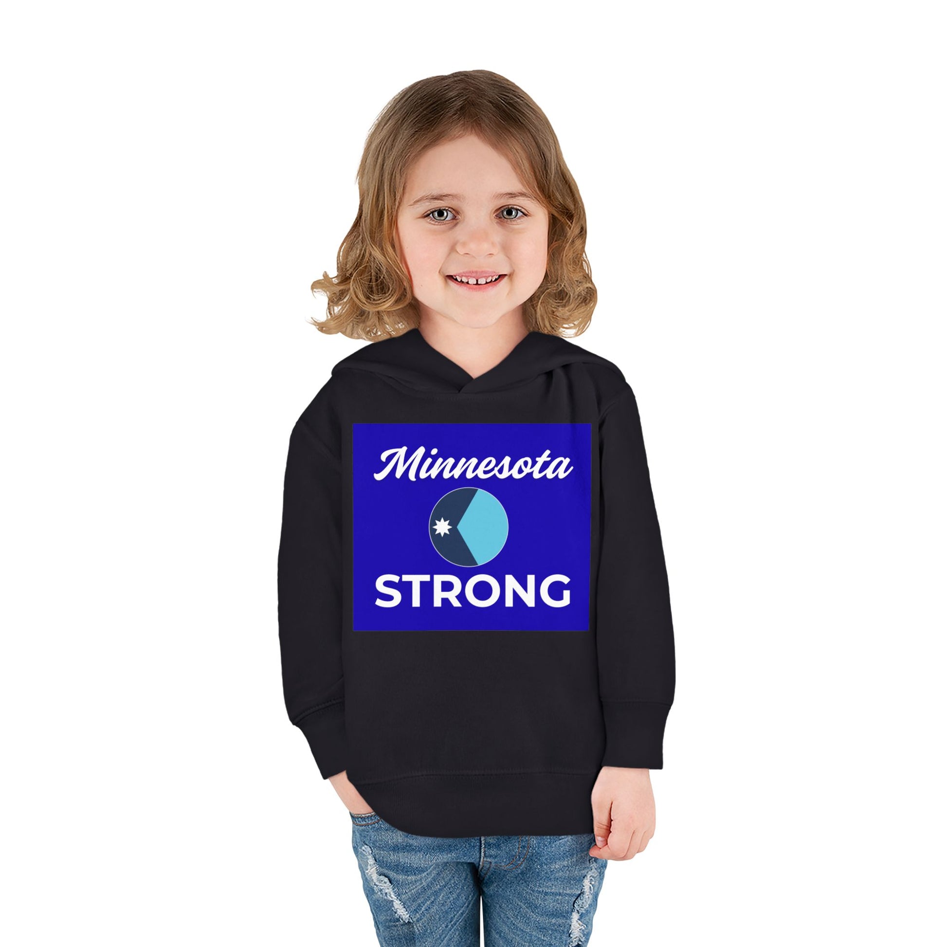 Toddler wearing Minnesota Strong hoodie, featuring a circular emblem and script, paired with light-blue jeans, embodying state pride and warmth.