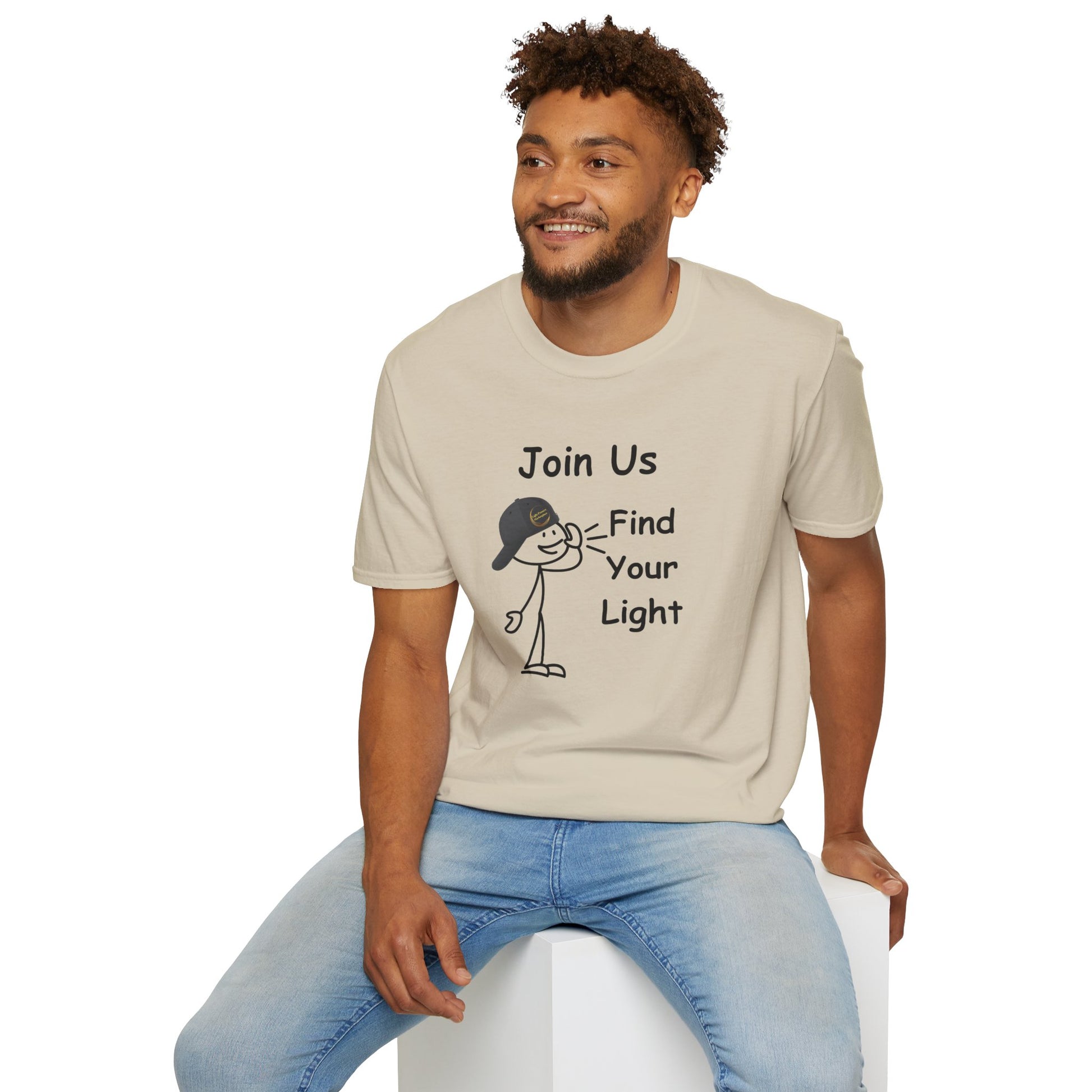 A man in a white soft-style t-shirt with a cartoon character, sitting on a cube. Unisex tee made of 100% ring-spun cotton, featuring twill tape shoulders and ribbed collar. Ethically sourced and Oeko-Tex certified.