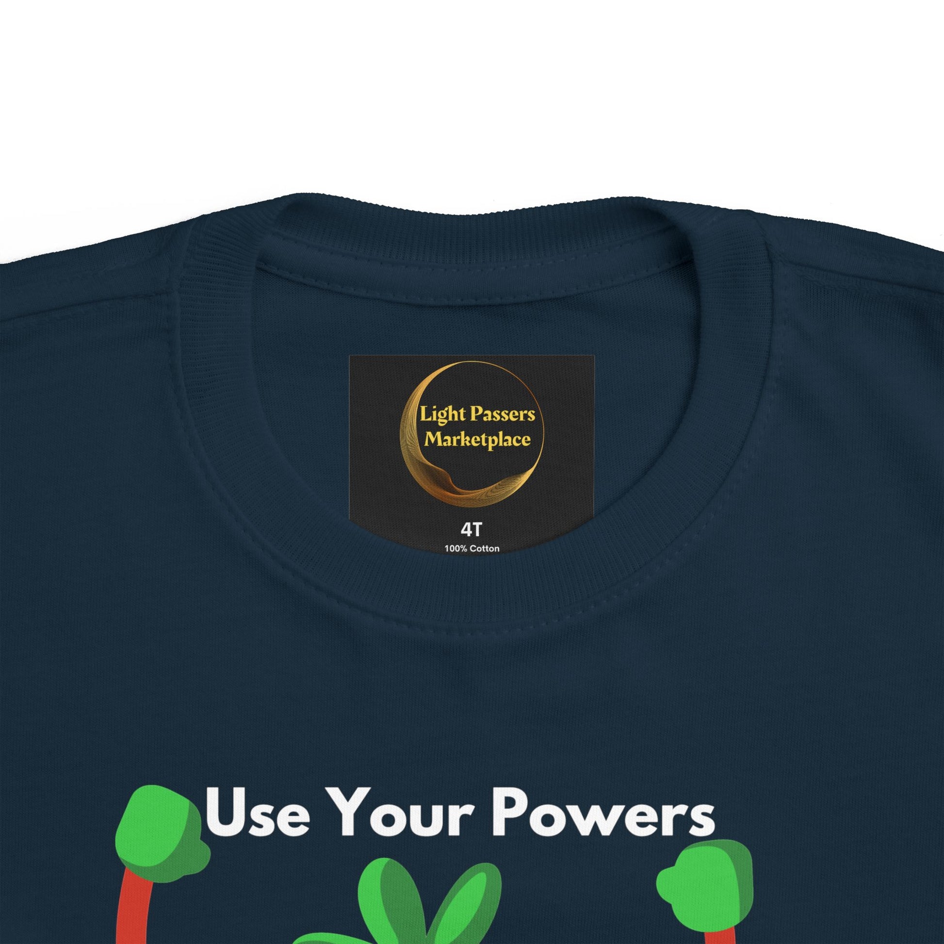 Health Tomato Power Toddler T-shirt, featuring Use Your Powers slogan and green plant/hand shapes, with Light Passers Marketplace printed inside collar.