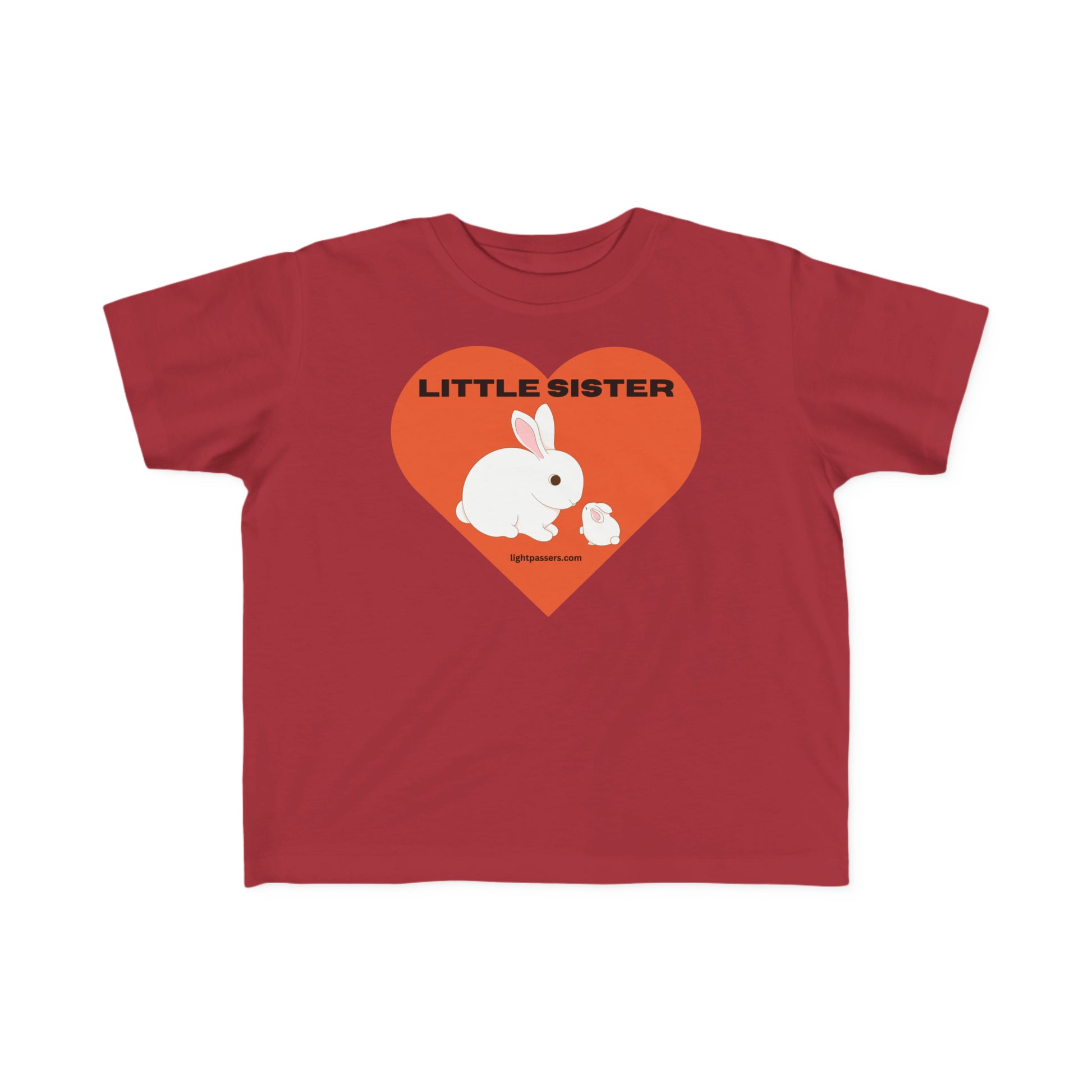 A Little Sister Toddler T-shirt featuring a white rabbit and heart design on red fabric. Soft, 100% combed cotton, durable print, tear-away label, and classic fit. Ideal for sensitive skin.