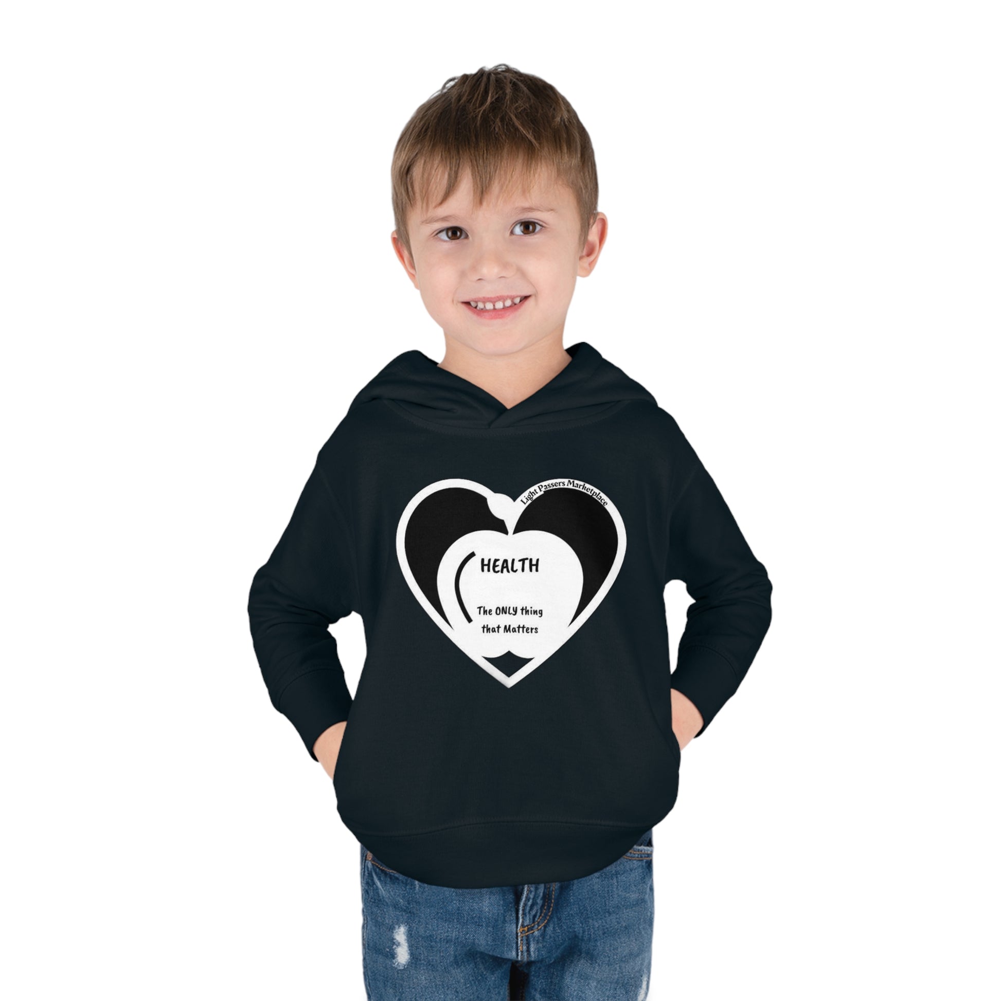 A smiling boy in a Rabbit Skins toddler hoodie with a heart design, showcasing jersey-lined hood, cover-stitched details, and side seam pockets for cozy wear.