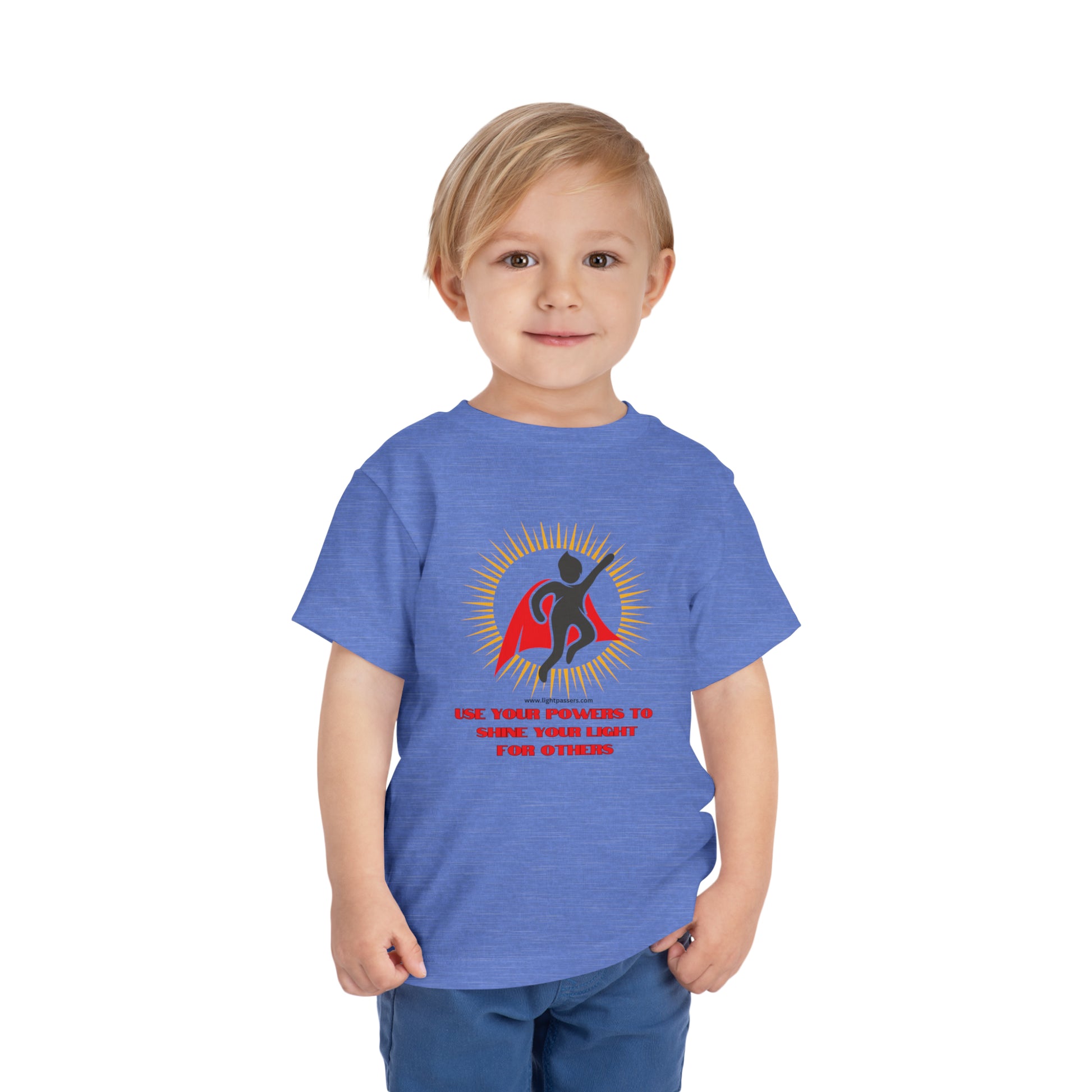 A toddler in a blue shirt with a cape, showcasing the Use Your Powers Toddler T-shirt. Made of 100% Airlume combed cotton, tear-away label for comfort.