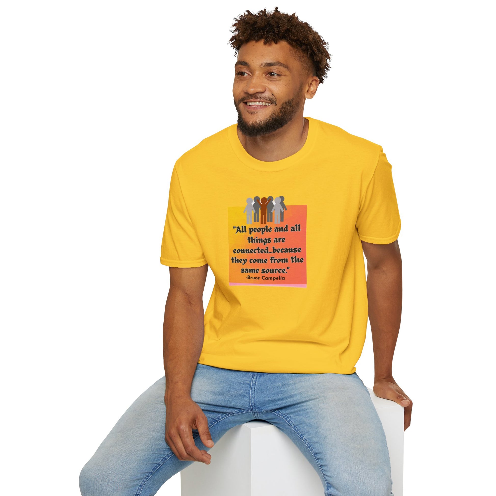 A man in a yellow shirt sitting on a cube, showcasing the All People are Connected orange plaque Unisex T-shirt. Casual, heavy cotton tee with smooth surface for vivid printing.