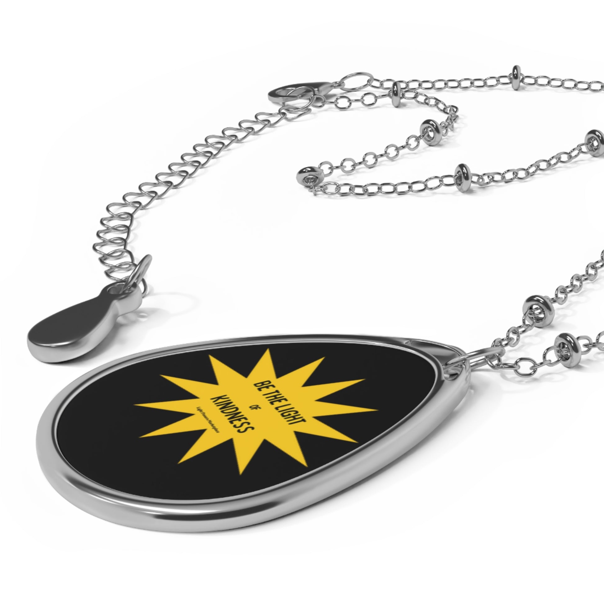 Necklace with Oval Pendant Be the Light of Kindness, featuring a silver chain and yellow sun design, ideal for spreading positivity and light.