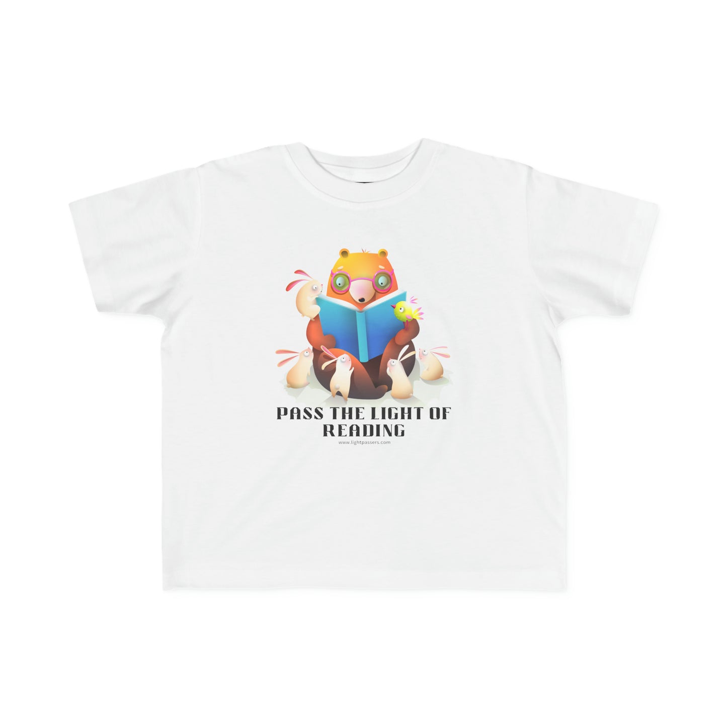 A toddler's Pass the Light of Reading T-shirt featuring a cartoon bear reading a book. Made of 100% combed cotton, light fabric, tear-away label, and a classic fit.