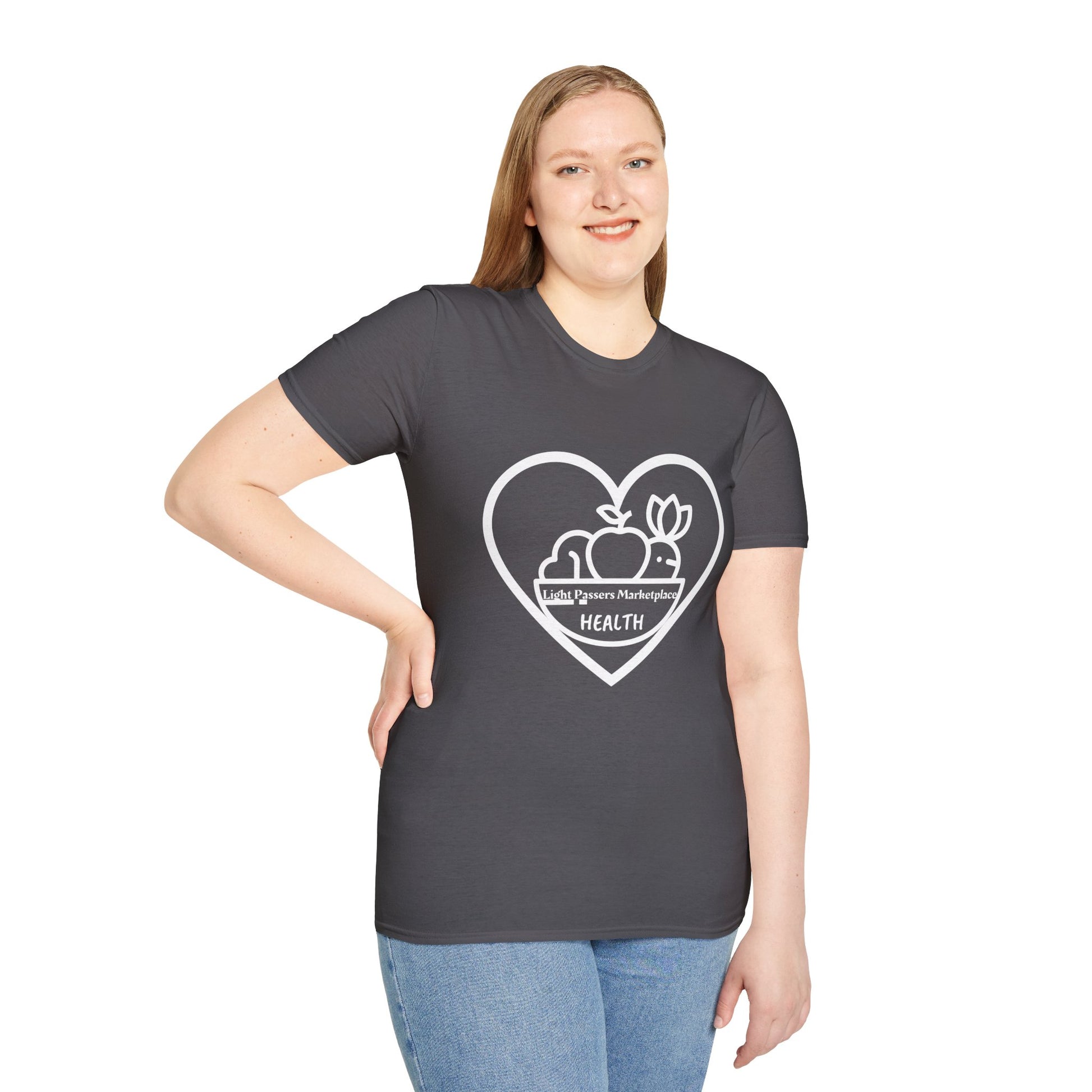 A woman in a grey shirt poses, showcasing the Light Passers Marketplace Fruit Basket Unisex T-Shirt. Close-up of blue jeans and a heart logo detail. Casual comfort with 100% cotton, twill tape shoulders, and ribbed collar.