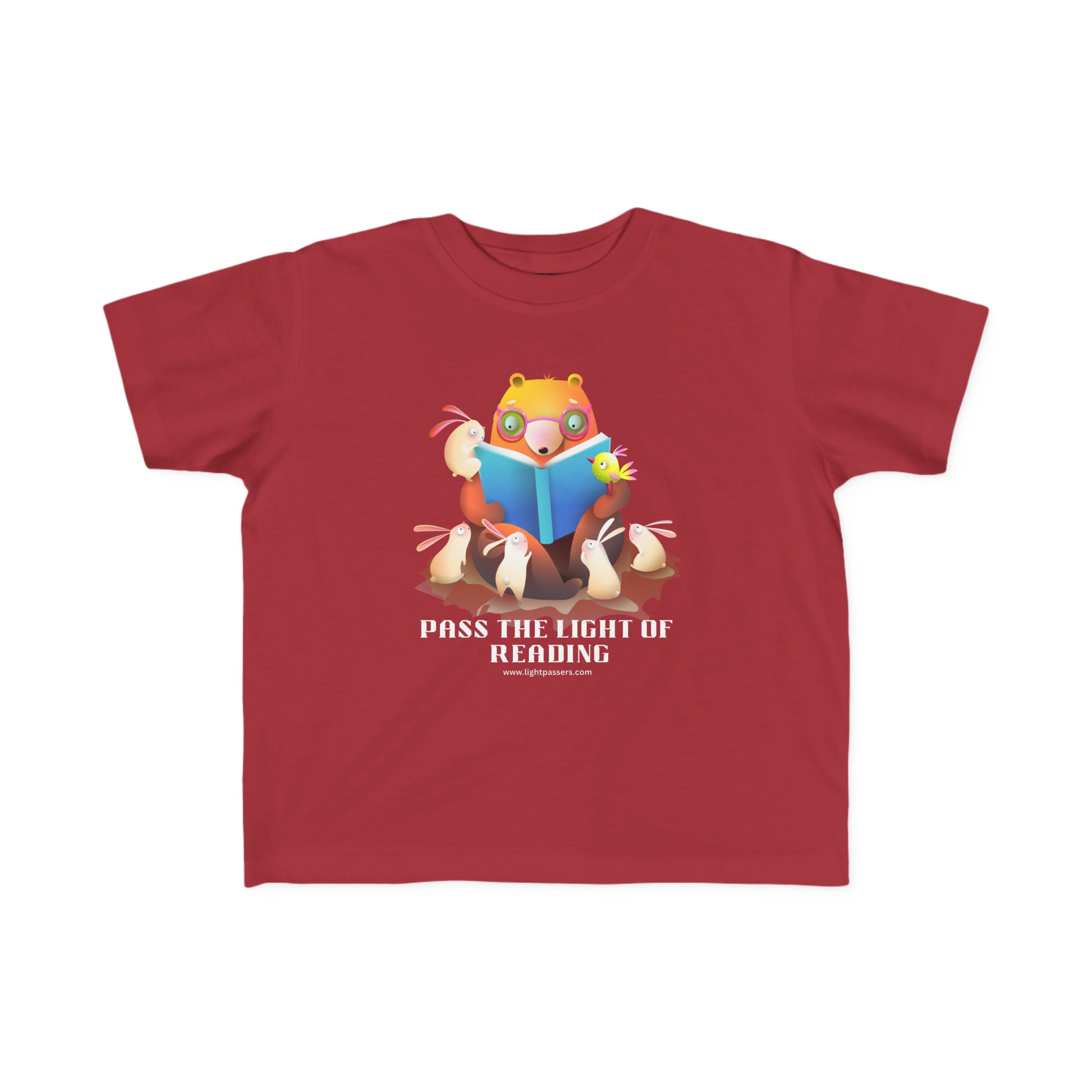 A red toddler t-shirt featuring a cartoon bear engrossed in reading a book. Made of soft, durable 100% combed cotton, with a tear-away label and a classic fit. Ideal for little book lovers.