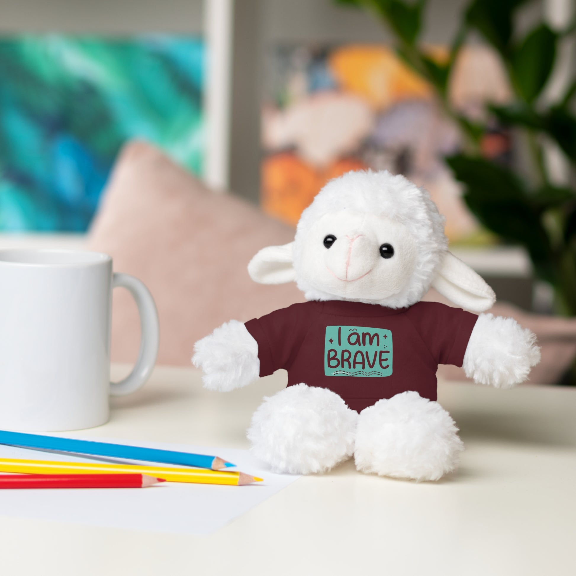 Cool Stuff Stuffies plush toy featuring a removable tee with I am Brave message, sitting on a table, perfect for children ages 3 and up.