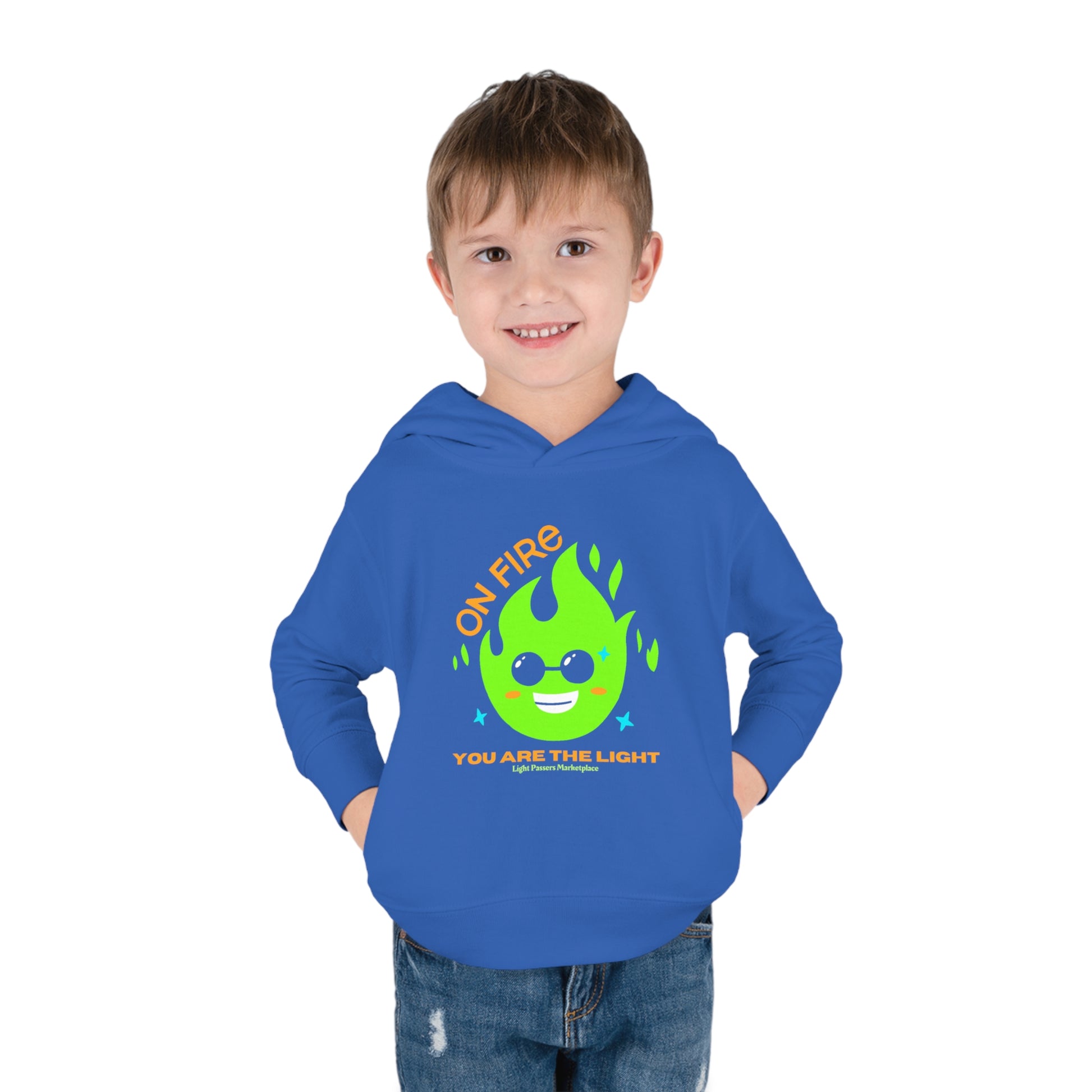 A toddler wearing a blue hoodie with a cartoon fire logo and sunglasses, featuring side seam pockets and cover-stitched details for durability and comfort.