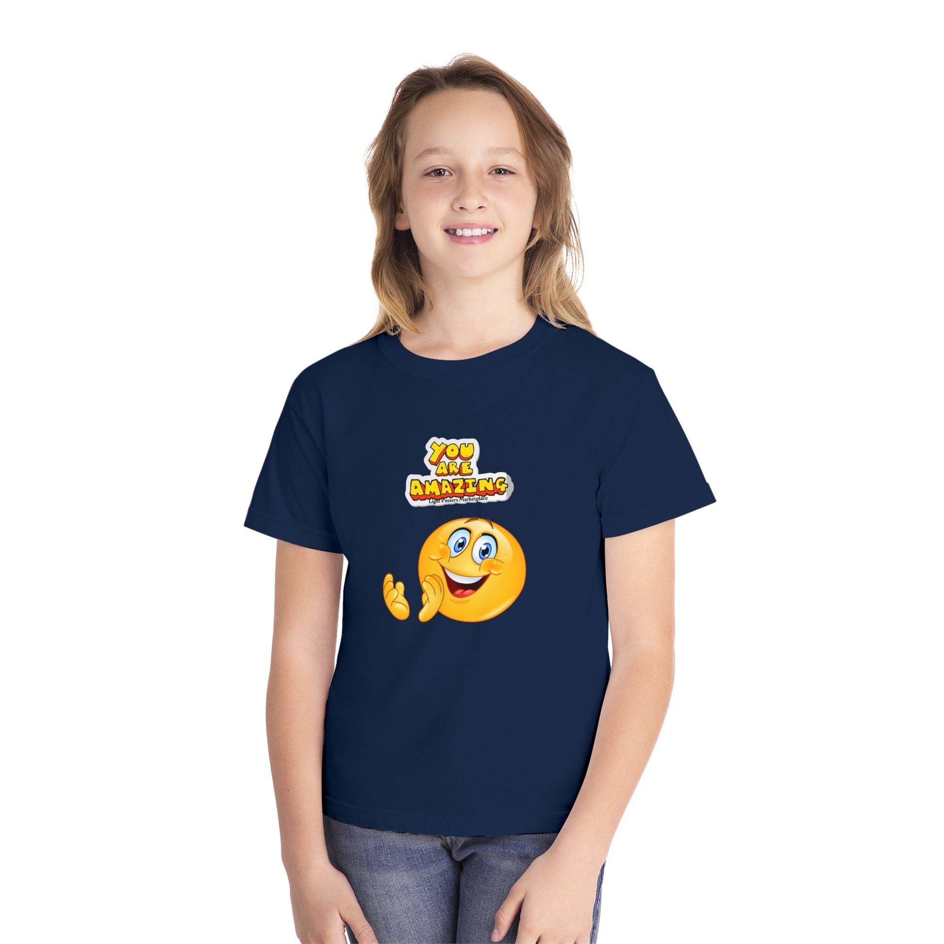 A girl in a blue shirt, close-up, smiling. Youth T-shirt: You are Amazing Clap. 100% combed cotton, soft-washed, classic fit for comfort and agility.