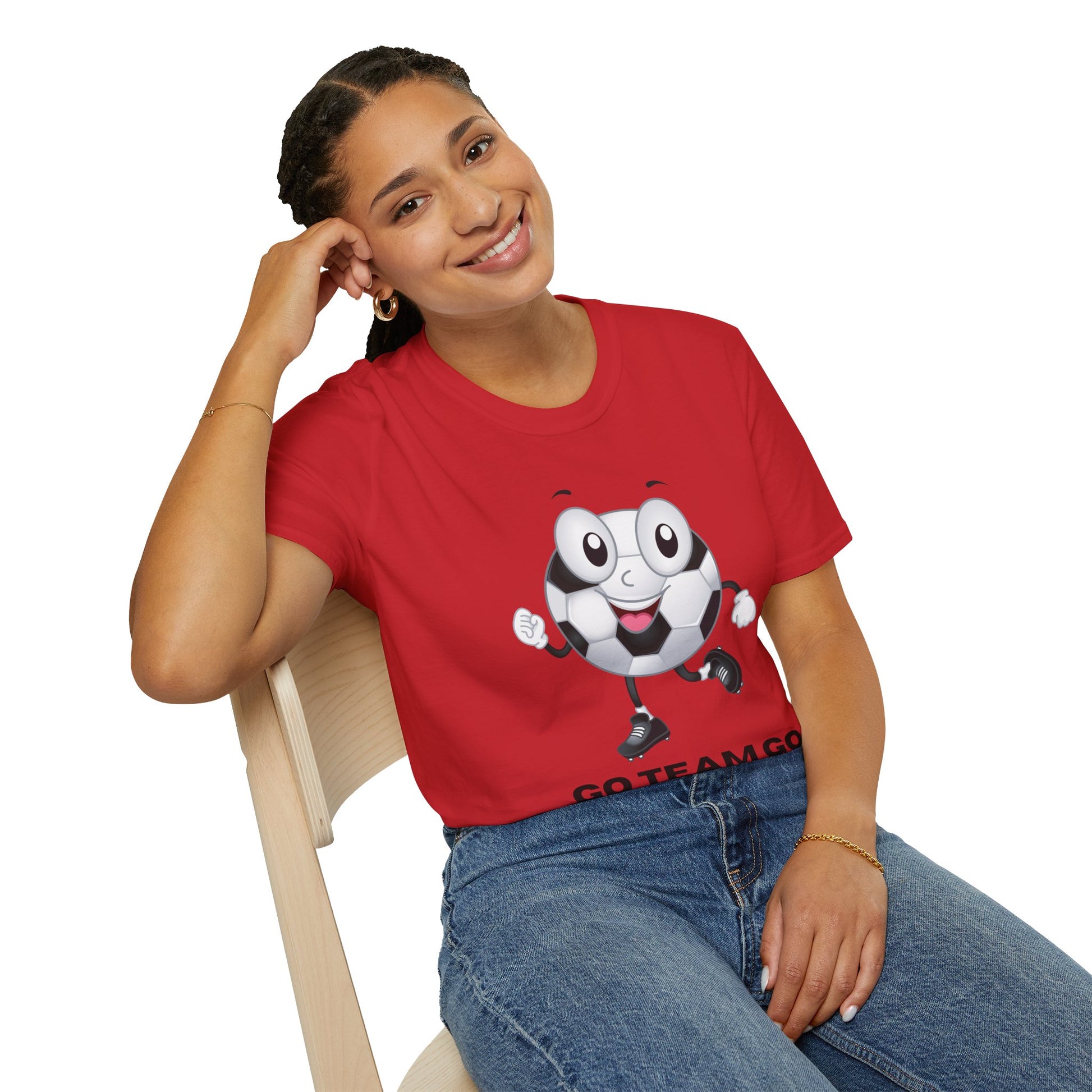 A woman in a red shirt smiles, sitting on a chair, showcasing the Soccer Ball Guy Team Unisex T-Shirt. Made of soft 100% cotton, with twill tape shoulders for durability and a clean crew neckline.