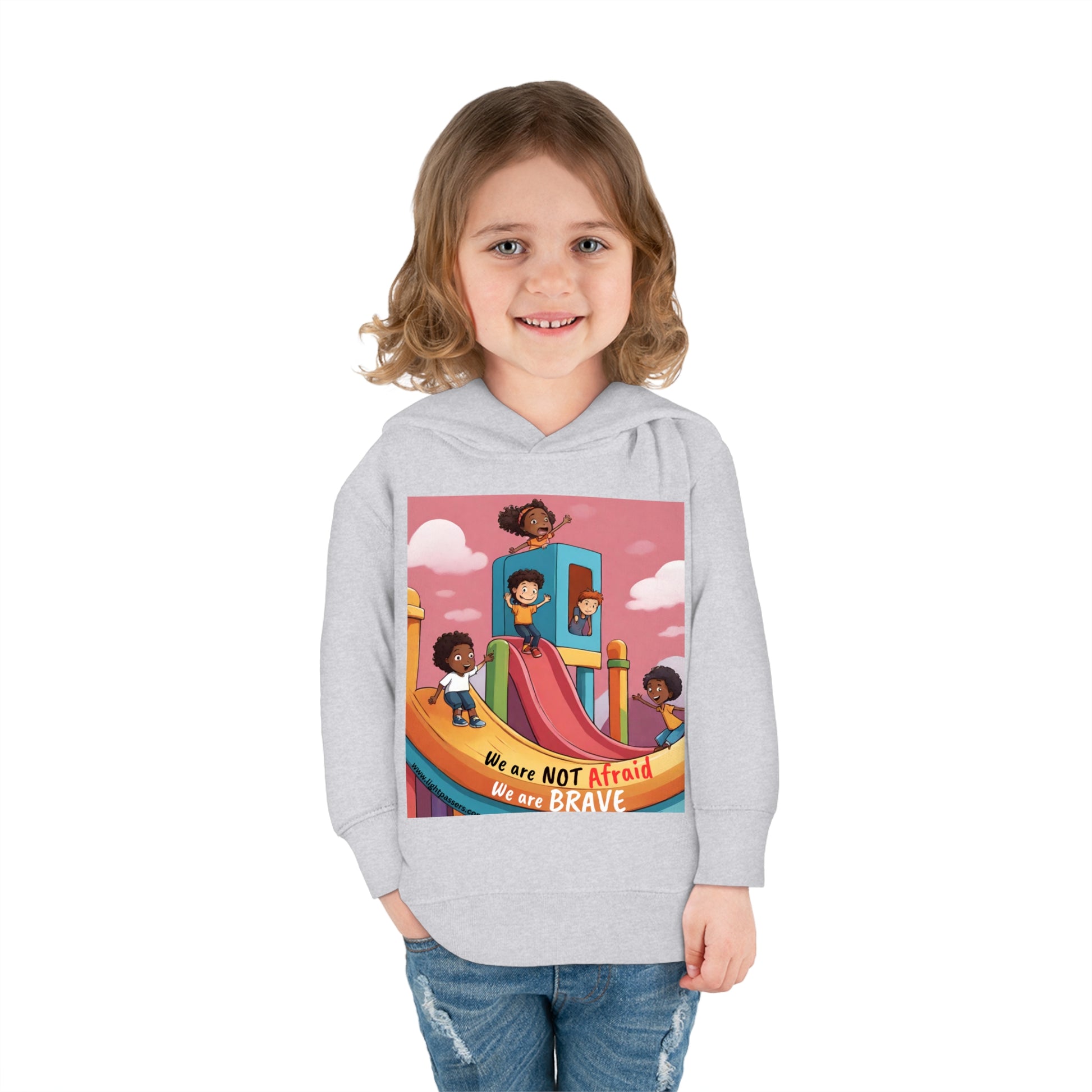 A child smiles in a Rabbit Skins toddler hoodie with a slide design. Features jersey-lined hood, cover-stitched details, and side seam pockets for cozy durability.