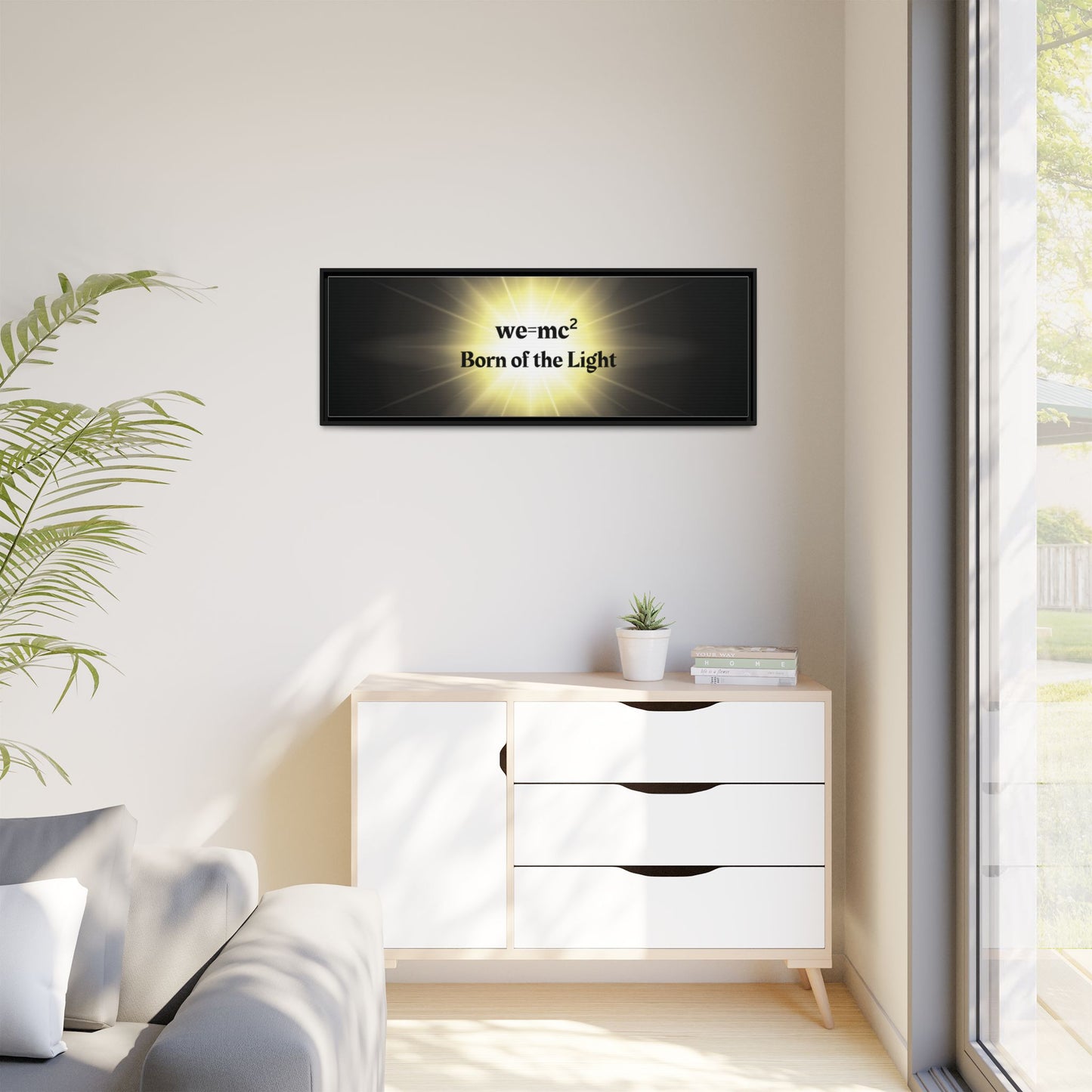 Inspirational Framed Canvas Art - we=mc² Born of the Light displayed in a cozy room with a couch, cabinet, and potted plant. Perfect for uplifting spaces.