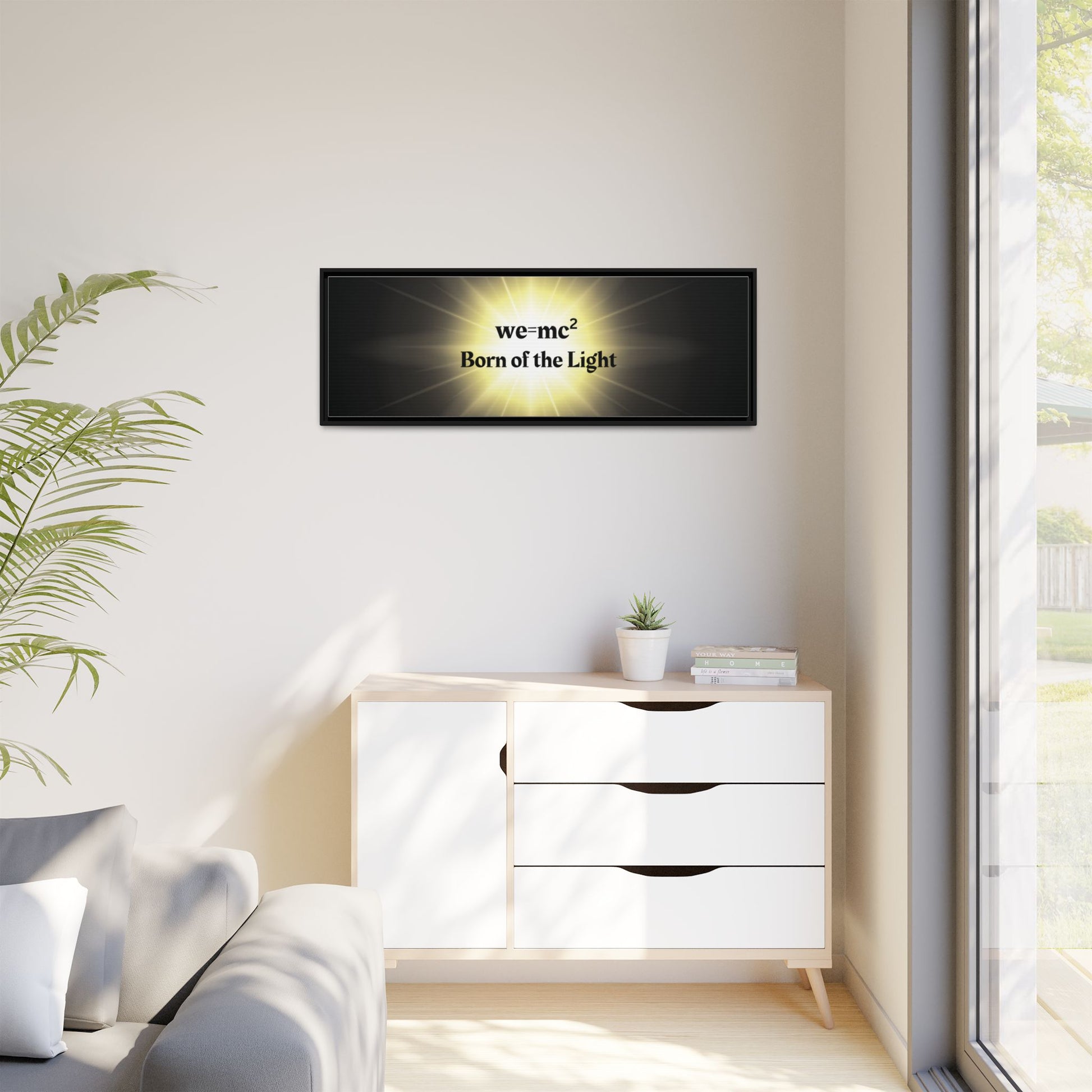 Inspirational Framed Canvas Art - we=mc² Born of the Light displayed in a cozy room with a couch, cabinet, and potted plant. Perfect for uplifting spaces.