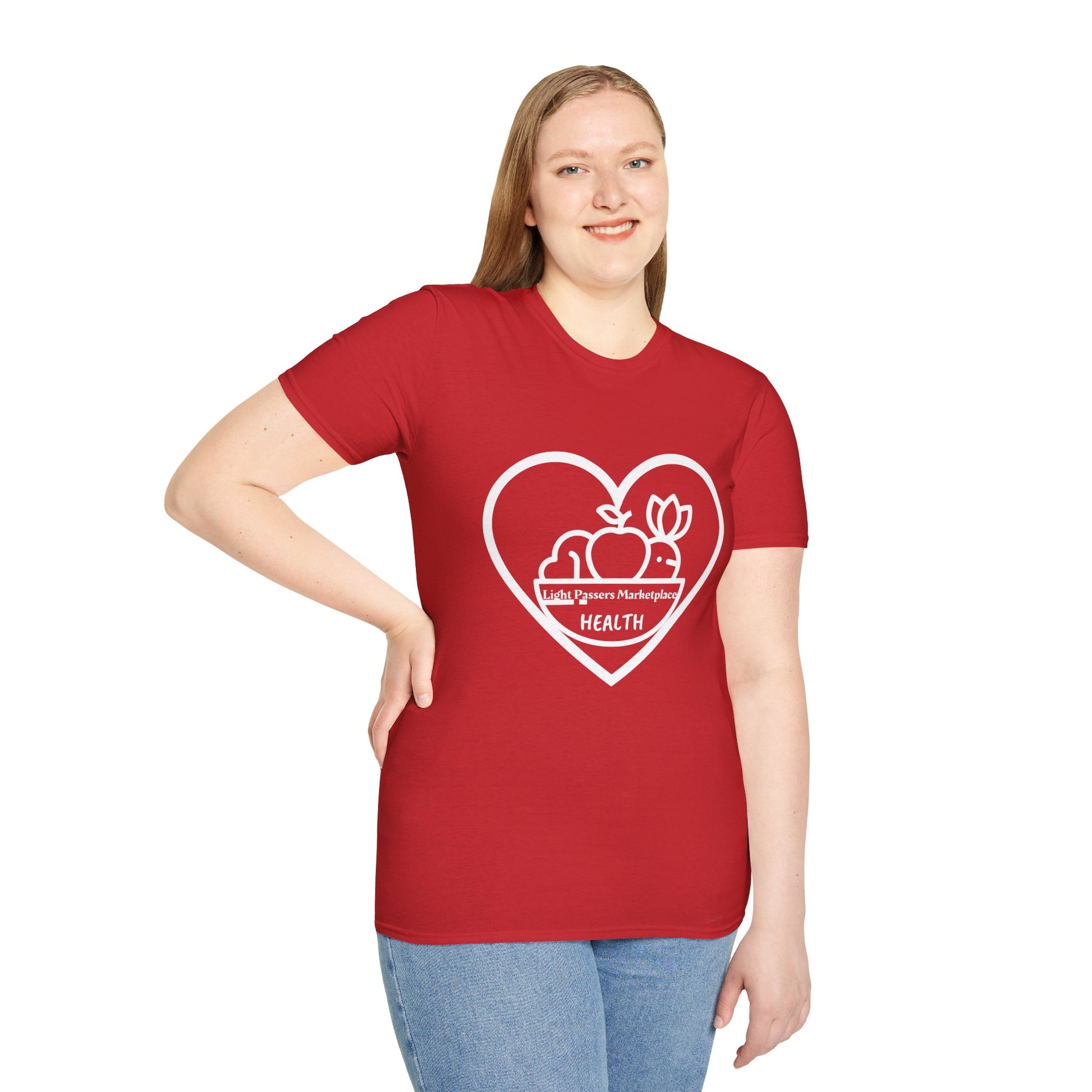 A woman in a red shirt smiles, showcasing the Light Passers Marketplace Fruit Basket Unisex T-Shirt. The shirt features a heart logo, soft cotton fabric, and a classic crew neckline for versatile style.