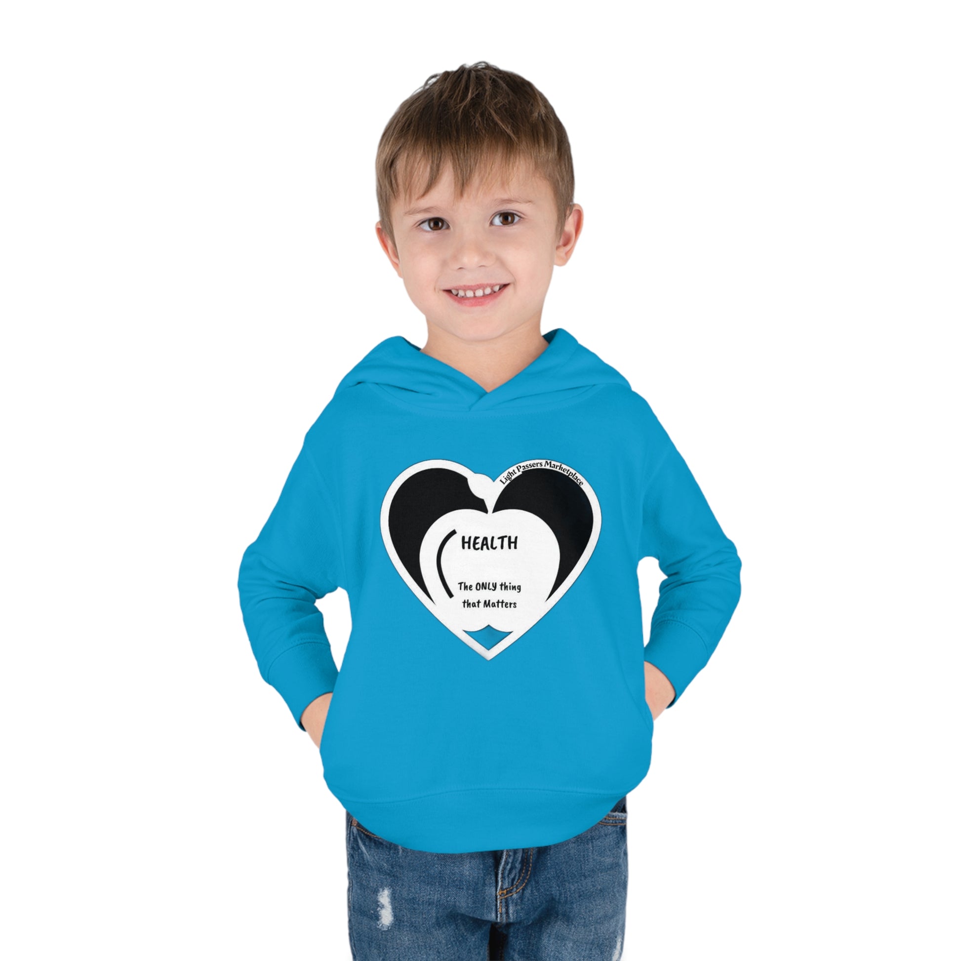 A smiling boy in a blue Rabbit Skins toddler hoodie with a heart design, showcasing jersey-lined hood, cover-stitched details, and side seam pockets for cozy durability.