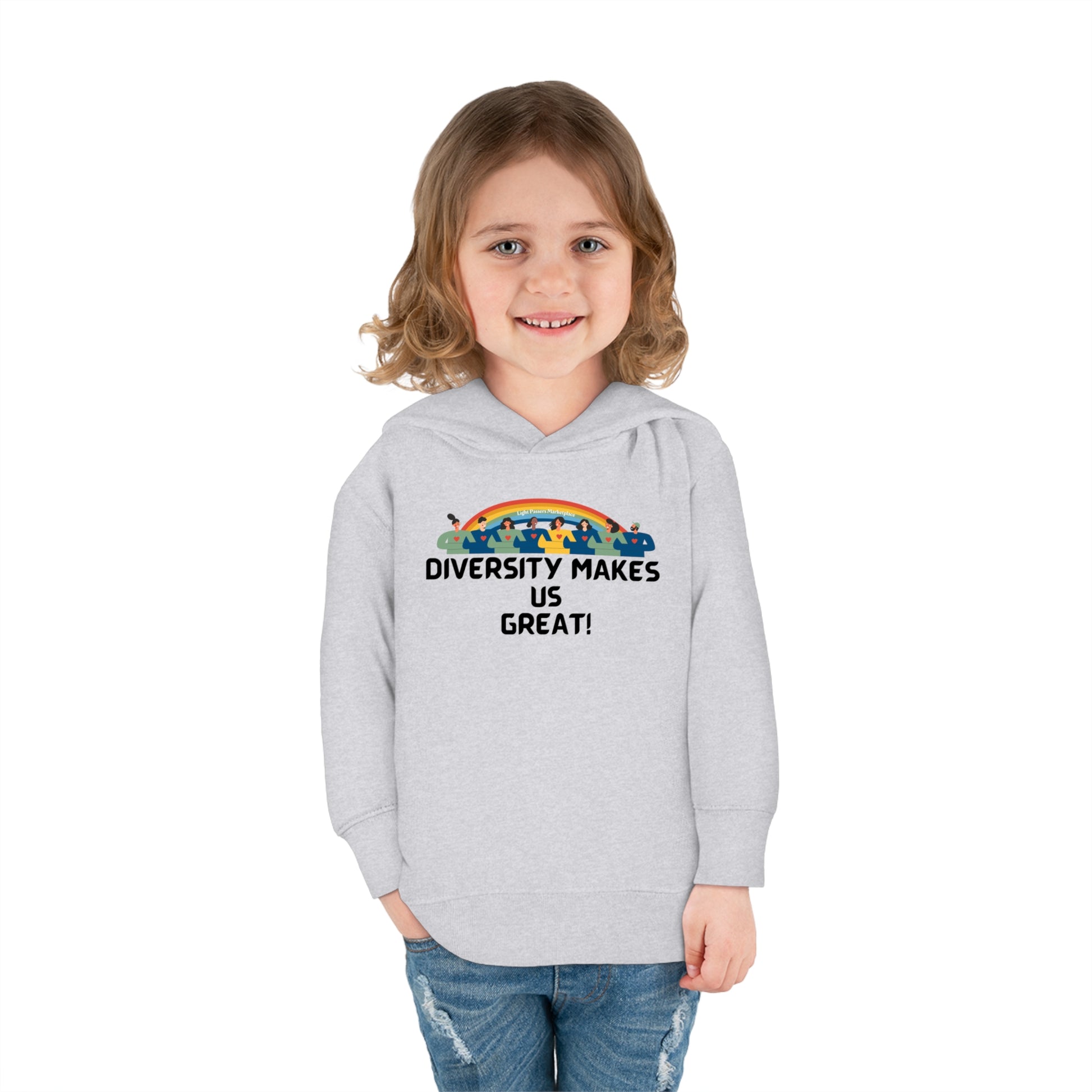 A child in a grey personalized toddler hoodie with a rainbow design smiles, showcasing the Rabbit Skins hoodie's durability and comfort features like side-seam pockets and cover-stitched details.