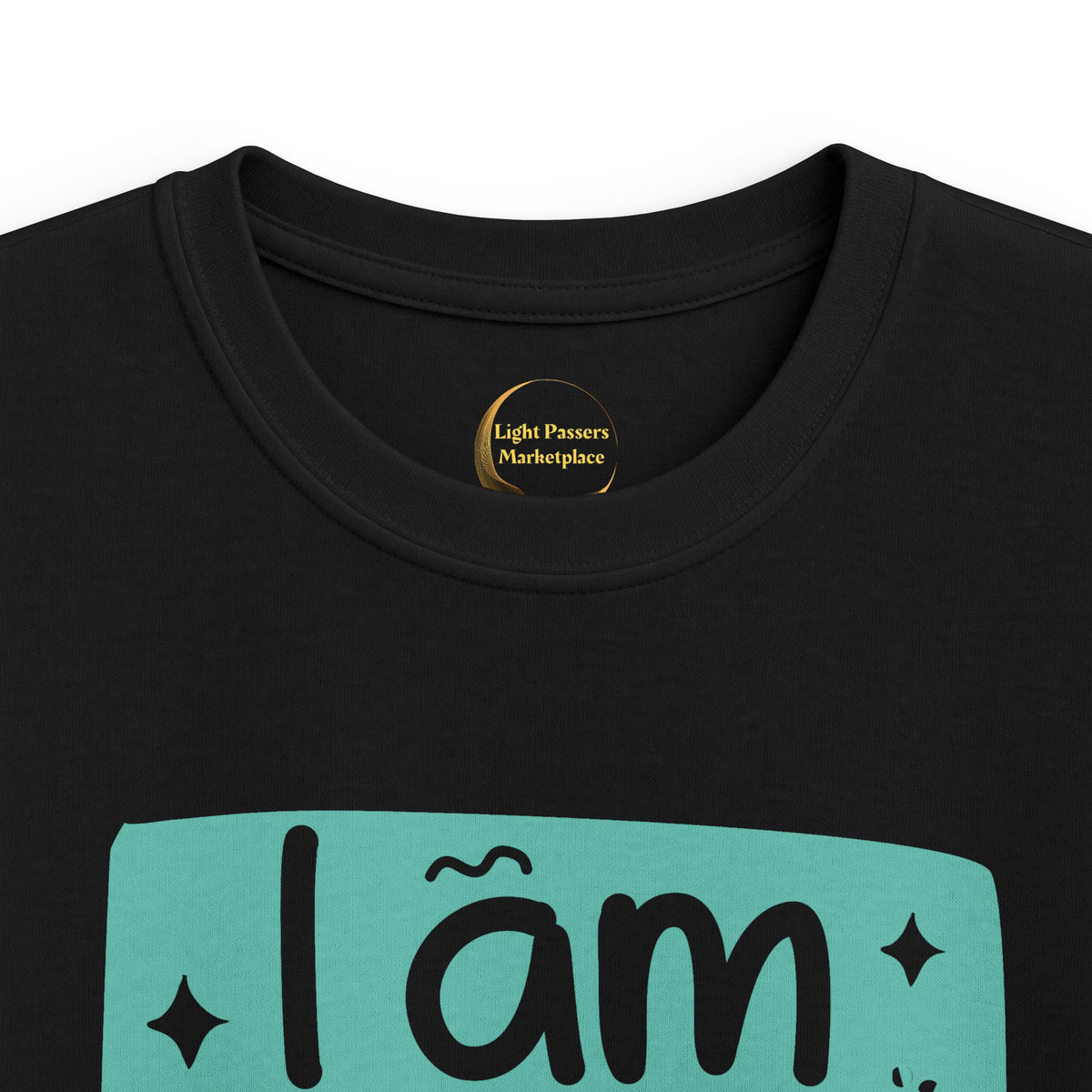 Black youth graphic T-shirt close-up with 'I am BRAVE' slogan on teal print
