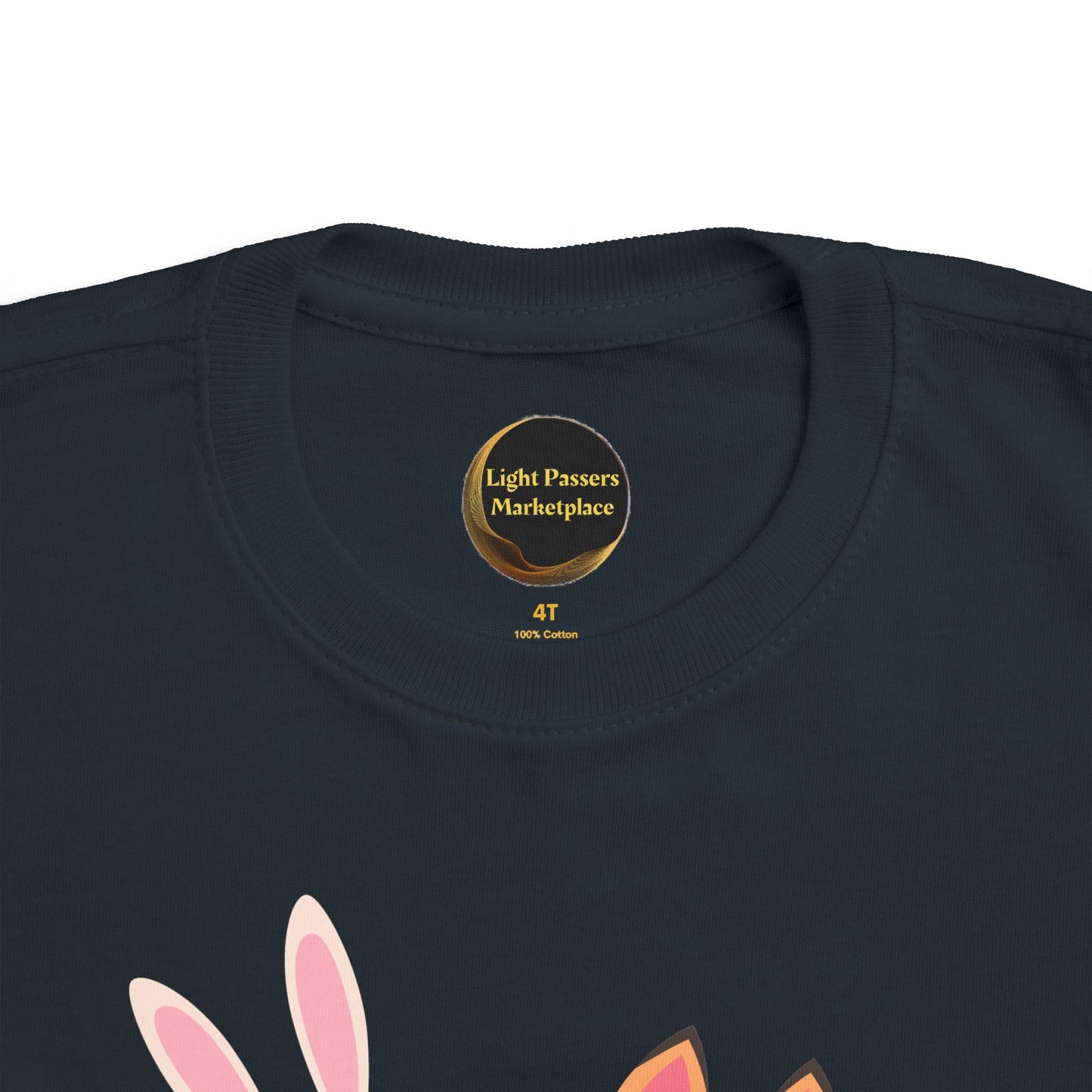 Children's navy cotton T-shirt, size 4T, with Light Passers Marketplace label. Features two bunnies reading, under Never Stop Reading message.