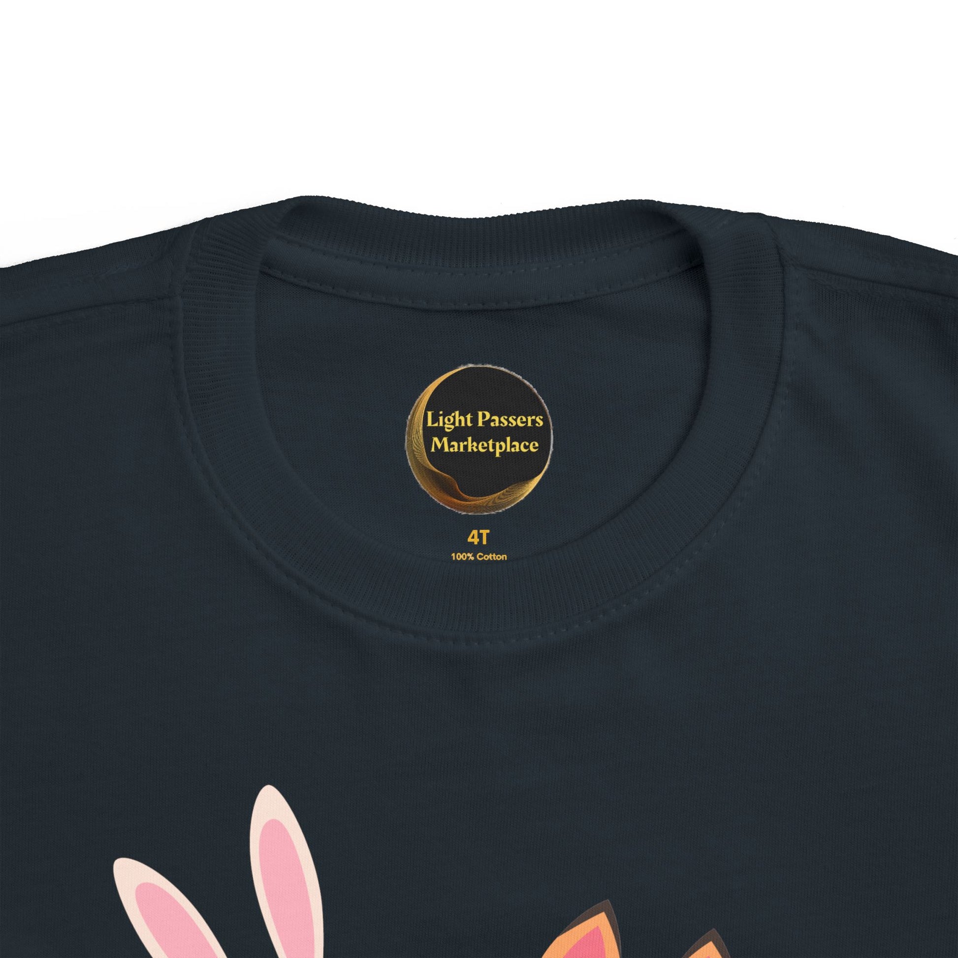 Children's navy cotton T-shirt, size 4T, with Light Passers Marketplace label. Features two bunnies reading, under Never Stop Reading message.