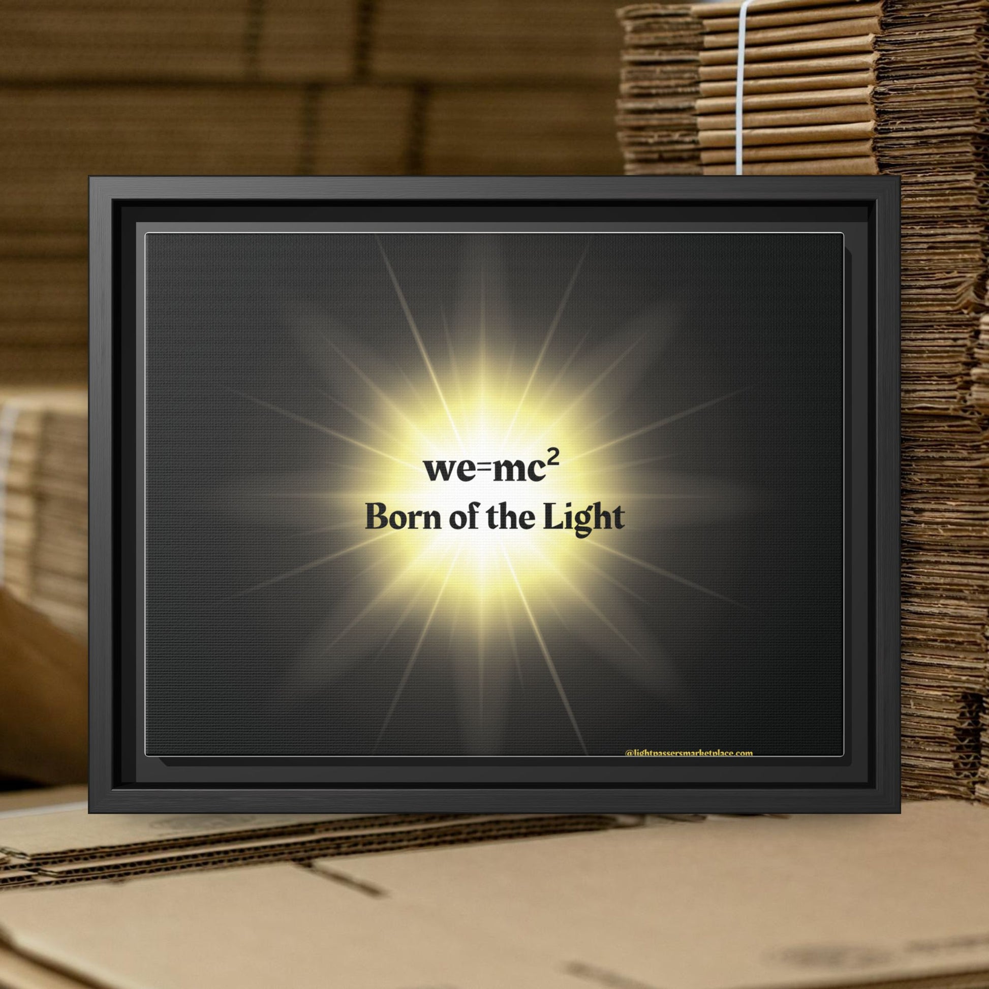 Inspirational Framed Canvas Art - we=mc² Born of the Light, featuring vibrant text on a matte canvas within a sleek black frame, perfect for inspiring creativity.