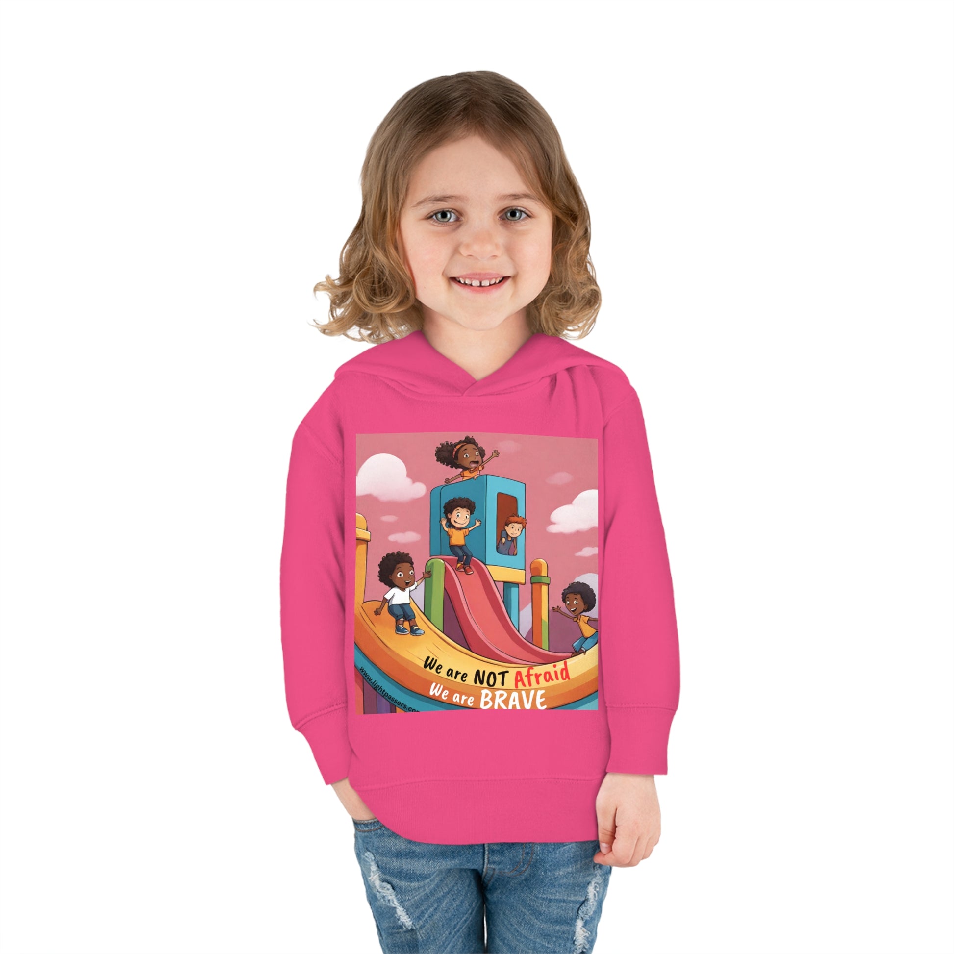 A smiling girl in a Rabbit Skins toddler hoodie with jersey-lined hood, cover-stitched details, and side seam pockets for cozy comfort.