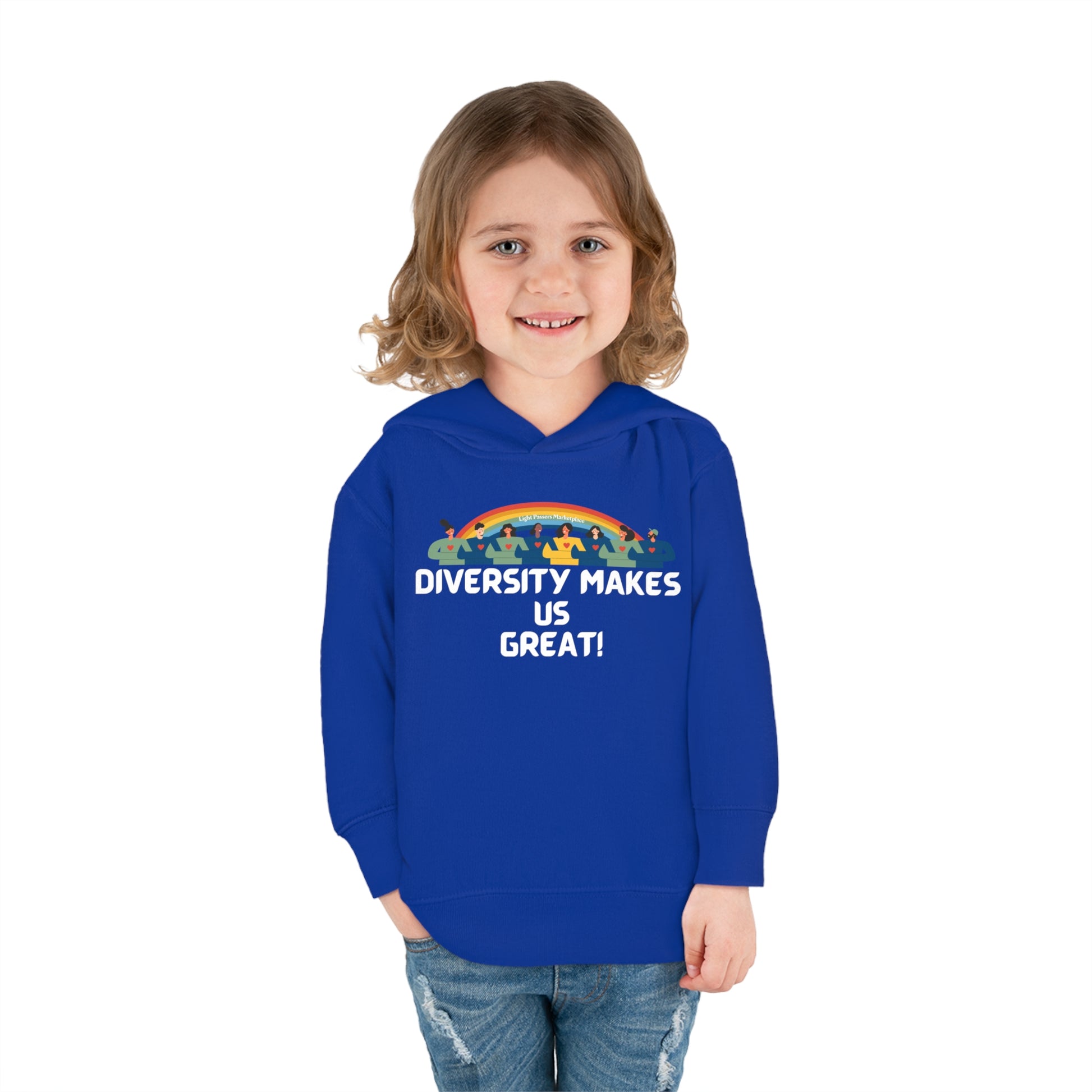 A smiling child in a Rabbit Skins toddler hoodie with rainbow design. Features jersey-lined hood, cover-stitched details, and side-seam pockets for cozy comfort.