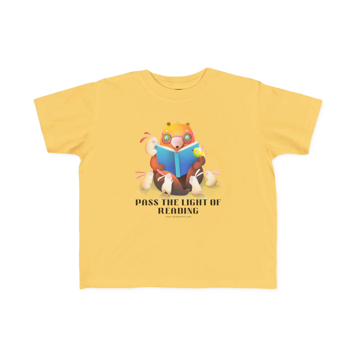 A Pass the Light of Reading Toddler T-shirt featuring a cartoon bear and bunny reading a book on a yellow shirt. Soft, durable tee for sensitive skin, 100% combed cotton, 4.5 oz/yd², tear-away label, true to size fit.