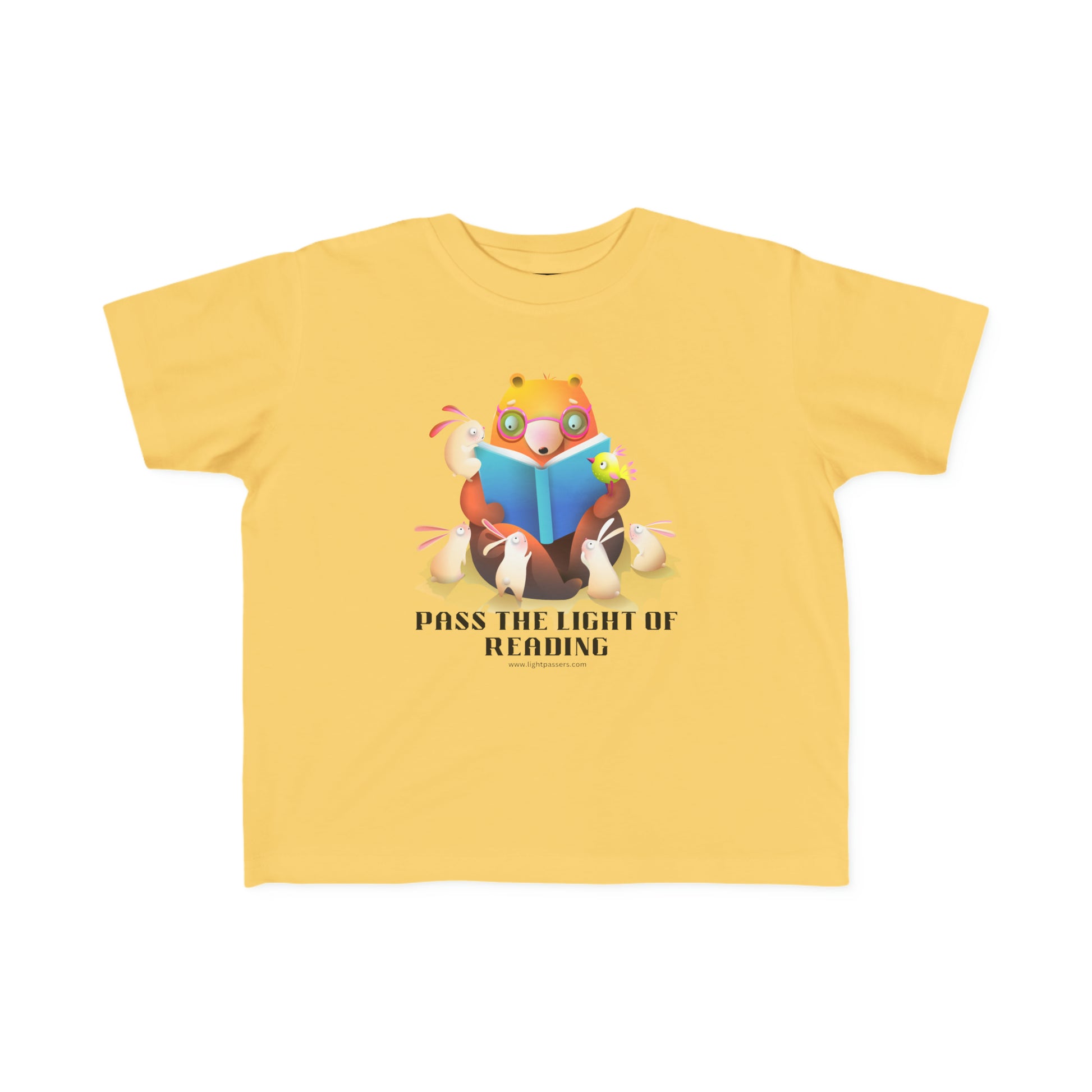 A Pass the Light of Reading Toddler T-shirt featuring a cartoon bear and bunny reading a book on a yellow shirt. Soft, durable tee for sensitive skin, 100% combed cotton, 4.5 oz/yd², tear-away label, true to size fit.