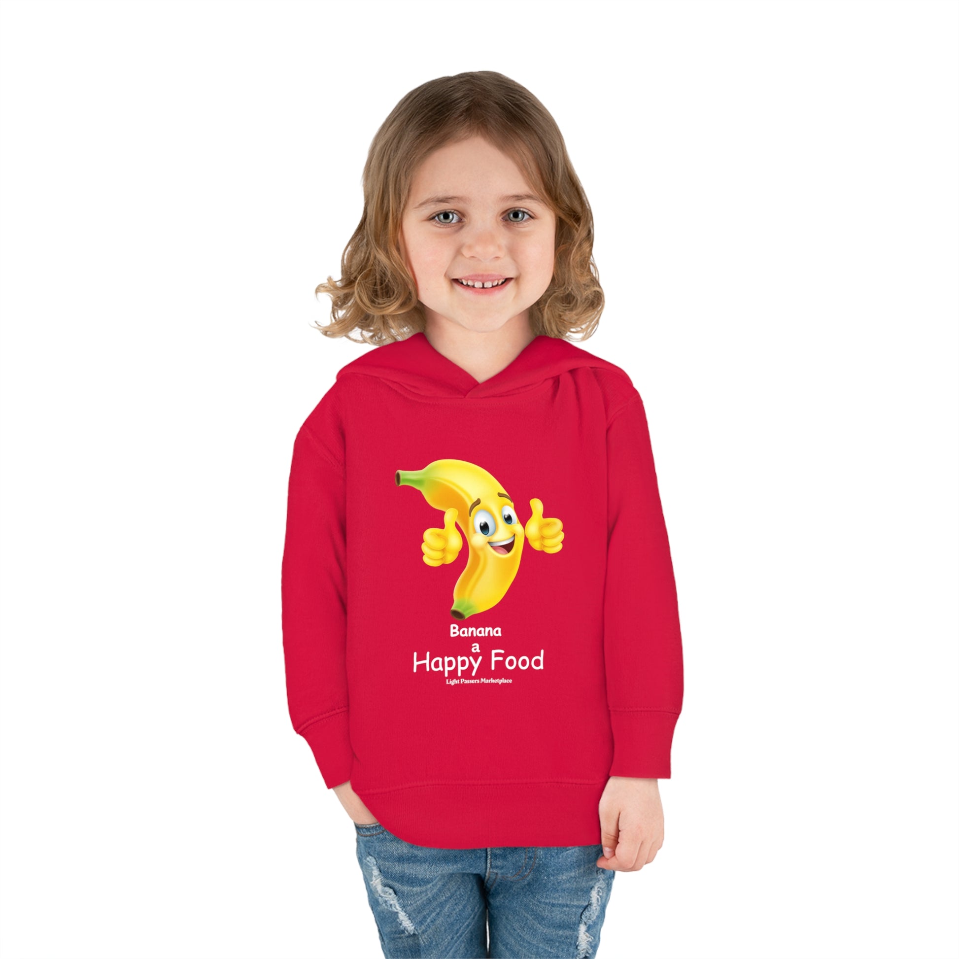 A toddler in a red Rabbit Skins hoodie with a cartoon banana giving a thumbs up. Features jersey-lined hood, side seam pockets, and durable stitching for cozy wear.