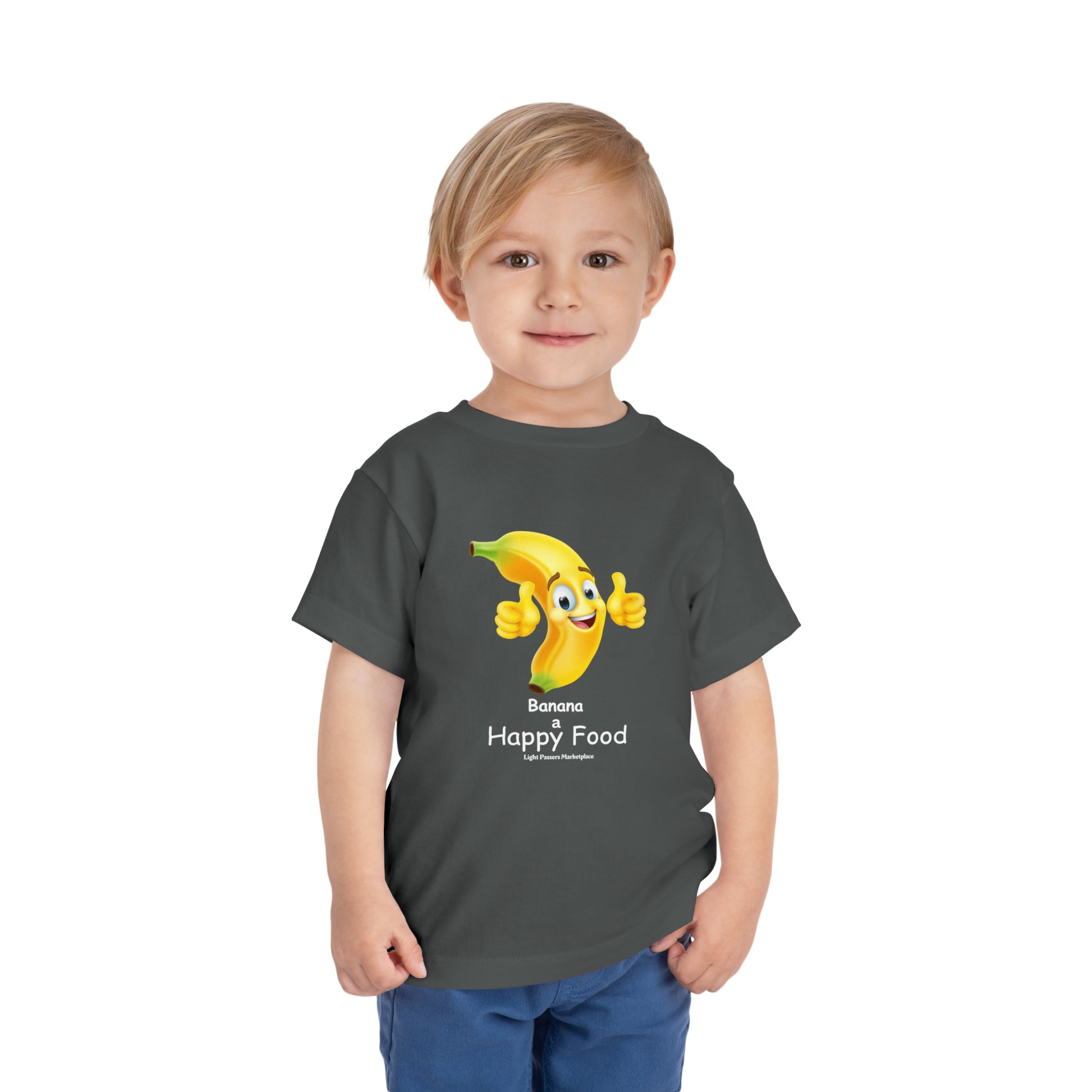 A toddler in a grey t-shirt featuring a cartoon banana giving a thumbs up. Bella Canvas tee made of 100% Airlume combed cotton, light fabric, tear-away label for comfort.