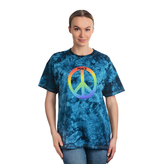 Model wears blue tie-dye T-shirt featuring rainbow peace sign and PEACE text, embodying a retro 60s-70s style from Light Passers Marketplace.
