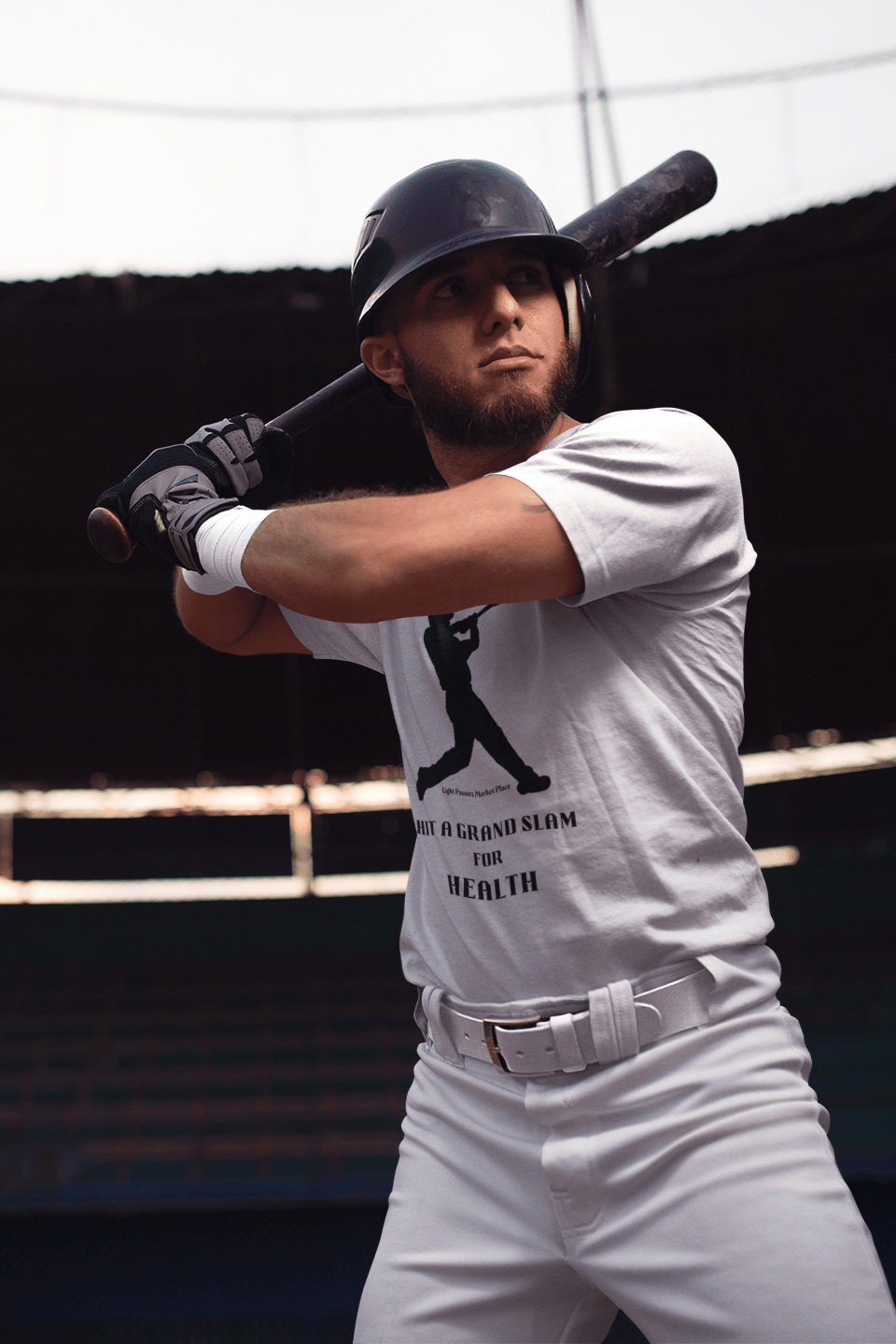 Man holding a baseball bat, wearing a Health Teams Grand Slam For Health Adult Unisex T-Shirt, showcasing its soft-style and classic fit suitable for athletic activities.