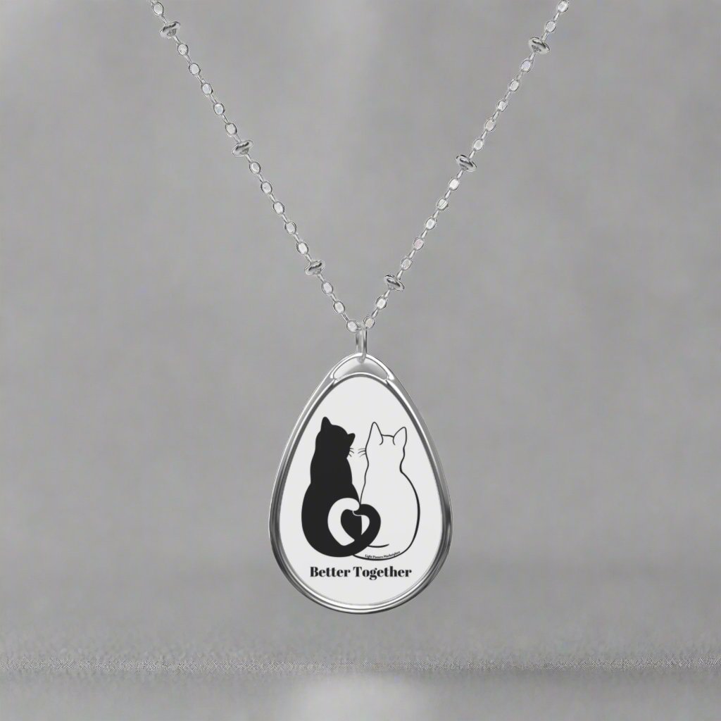 Silver necklace with ellipse-shaped pendant, featuring 'Better Together 2 Cats Love Tails', ideal for cat lovers. Lobster clasp ensures secure wear.