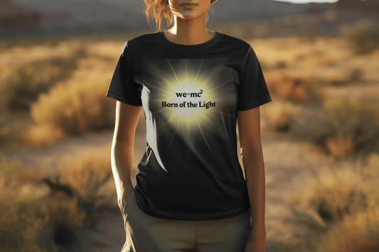 The Light 'we=mc2 Born of the Light' Adult Unisex T-Shirt, featuring a woman modeling its comfortable fit, embodies science-inspired design and casual elegance.
