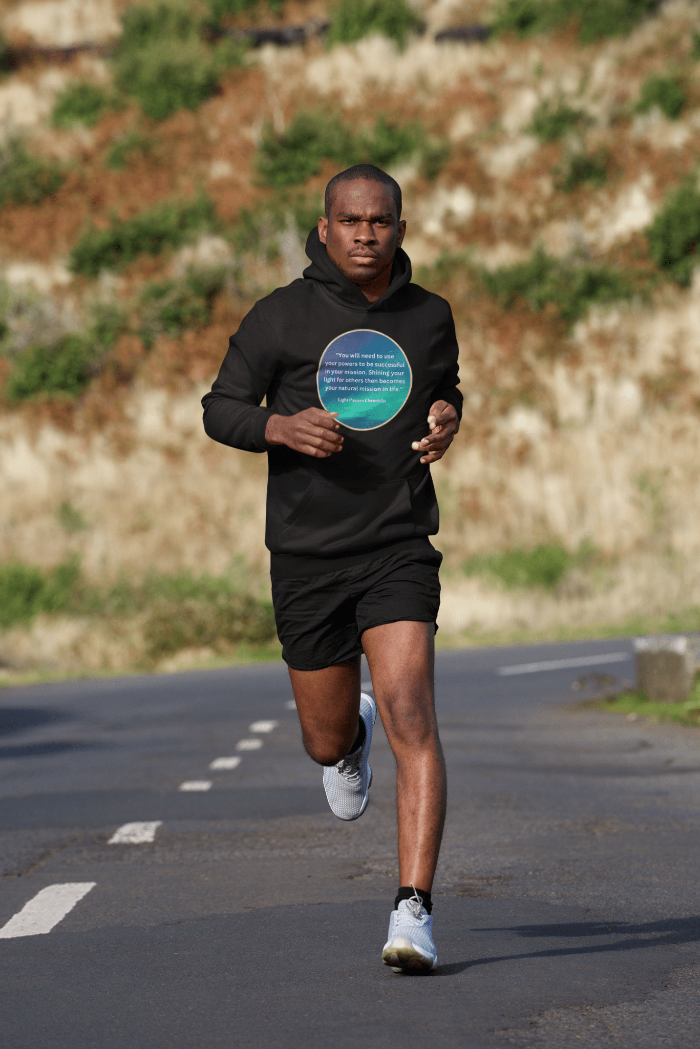 A person in a black hoodie running on a road, holding a circular object, showcasing the Use Your Powers turquoise circle Unisex Hooded Sweatshirt's comfort and style.