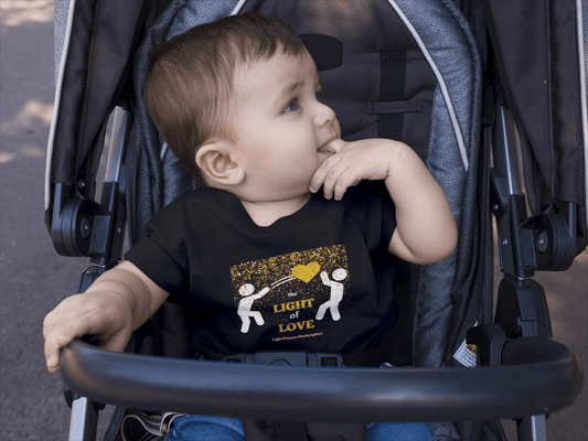 A baby in a stroller wearing the Light of Love Gold Heart T-shirt, a durable infant tee with ribbed knitting, taped shoulders, and soft cotton fabric.
