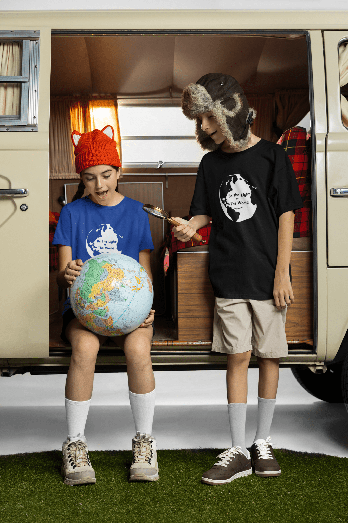 Youth tee featuring a boy and girl in hats looking at a globe, embodying innocence and curiosity. Made of soft cotton, light fabric, tear-away label, and a high-quality print.