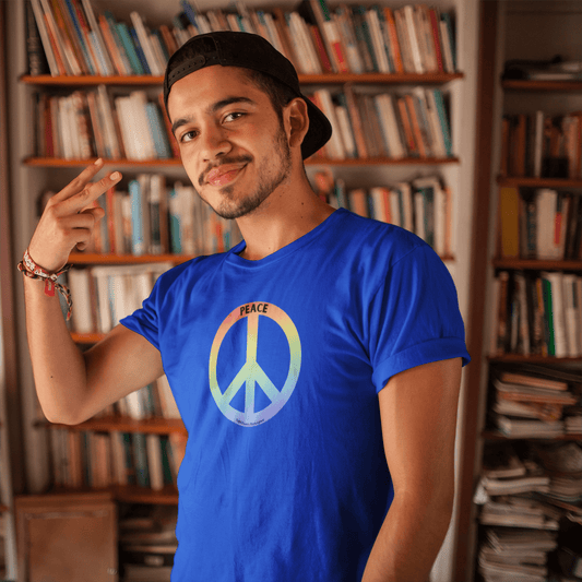 A man in a blue shirt wearing a peace sign color Unisex T-shirt, showcasing soft 100% cotton fabric, twill tape shoulders, and ribbed collar for durability and comfort.