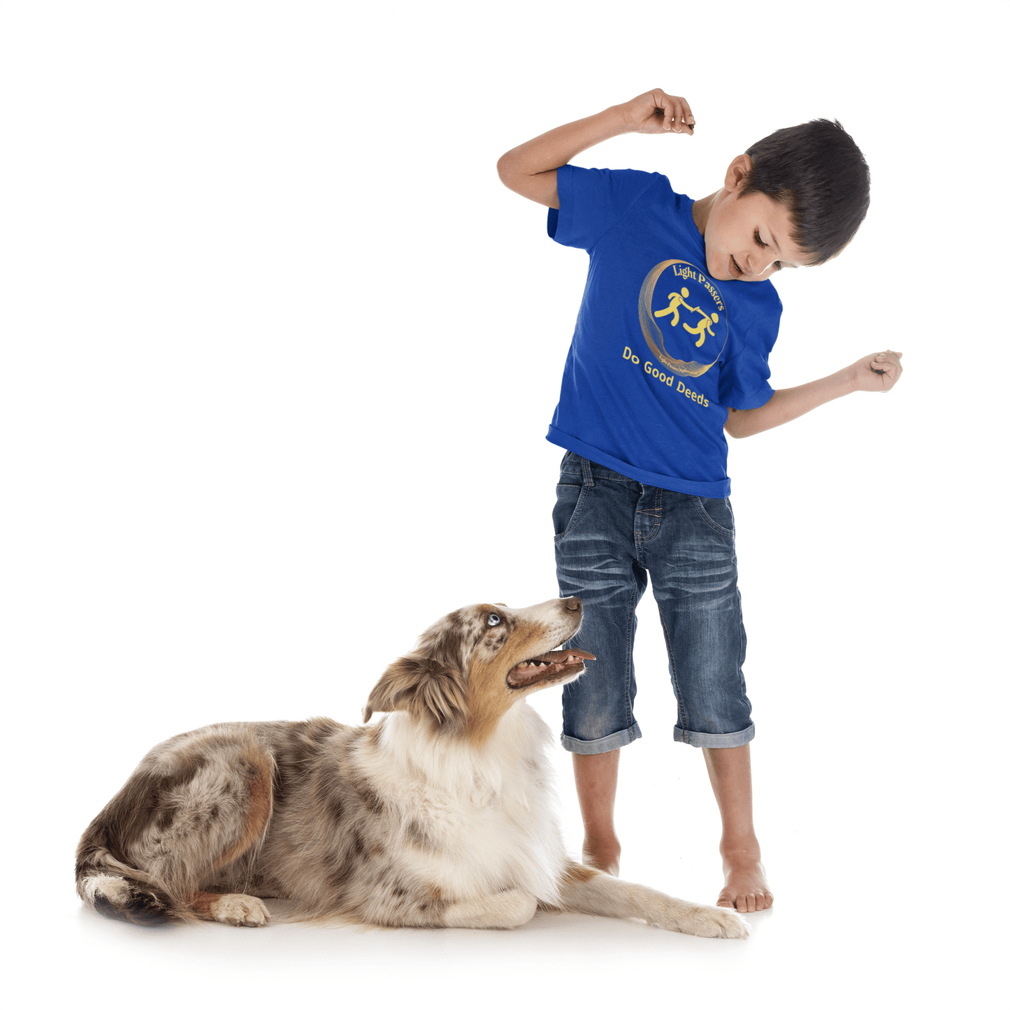 A boy in a blue shirt and jeans stands next to a dog, showcasing the Light Passers Relay Do Good Deeds Youth T-shirt. The image features a toddler, a person, and a dog, emphasizing the tee's 100% cotton fabric, tear-away label, and classic fit.