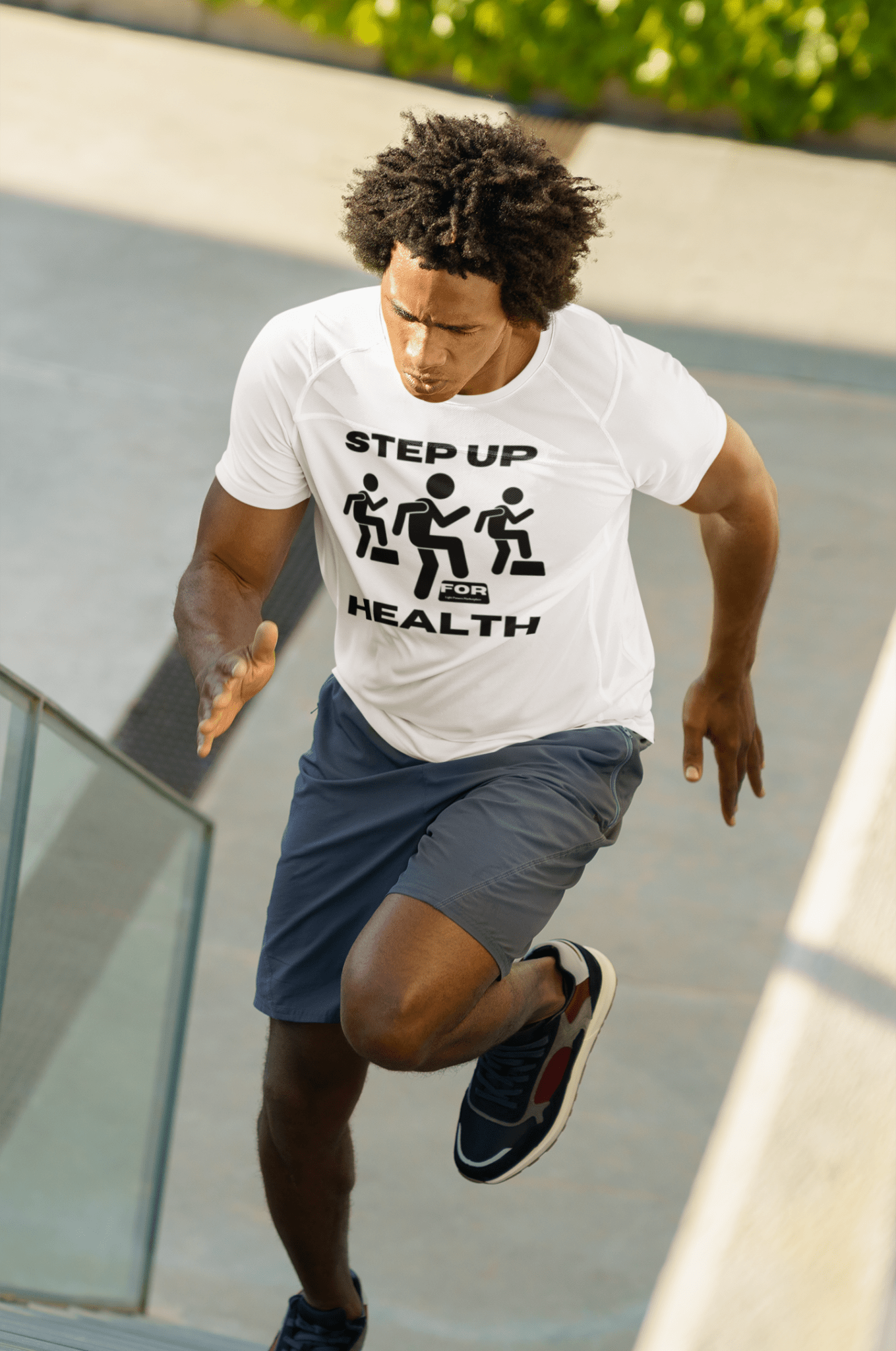 A man in a white shirt running up stairs, showcasing the Step Up For Health Unisex T-Shirt's comfort and durability. Made of soft, 100% cotton with twill tape shoulders and ribbed collar.