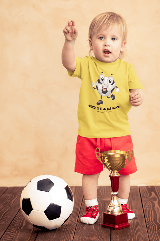 A toddler proudly holds a trophy, surrounded by a football ball and a close-up of a trophy. The image features a child wearing a yellow shirt and a sock. The focus is on sports and achievement.